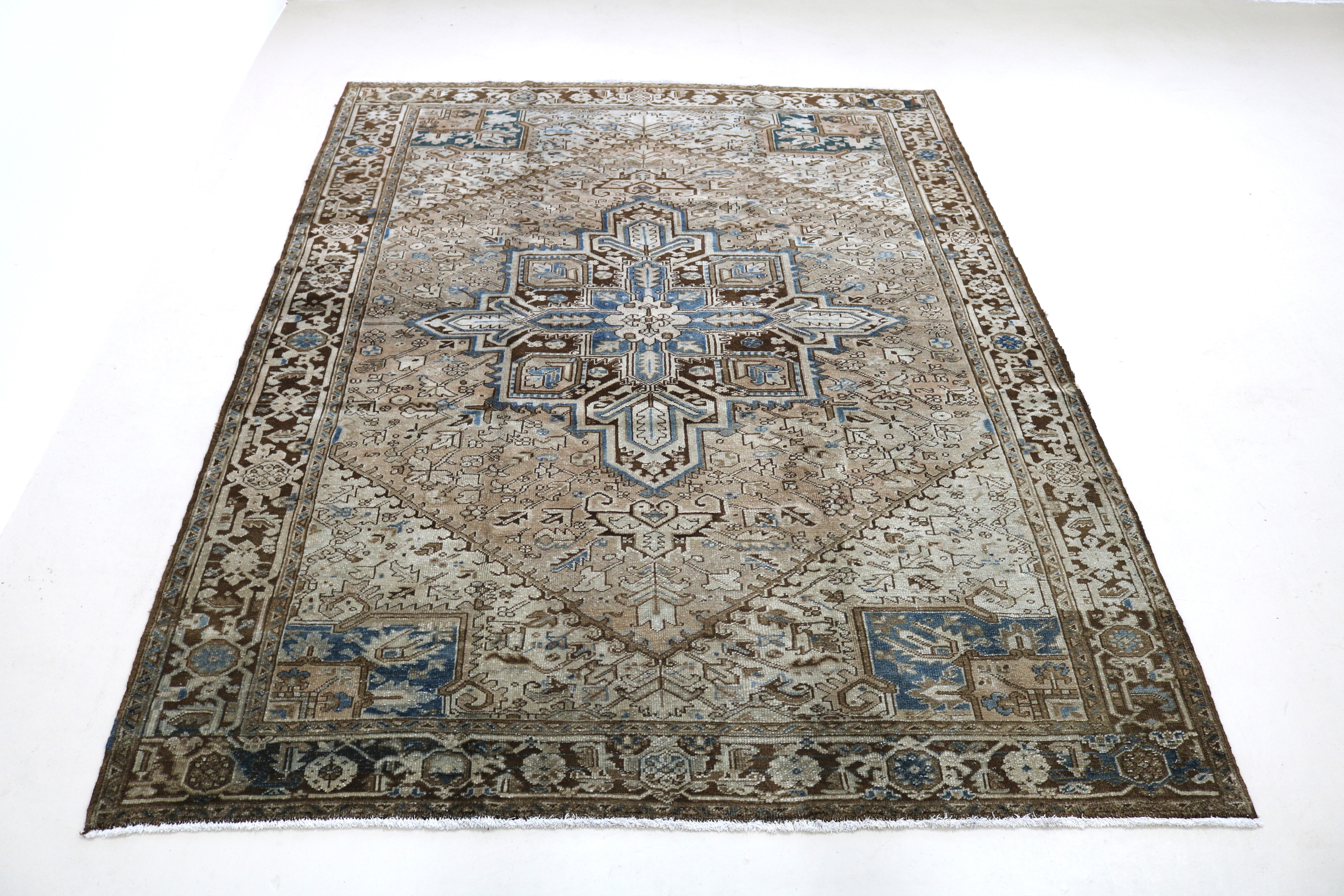 Full view of antique Persian Heriz carpet with strong geometric field and traditional borders