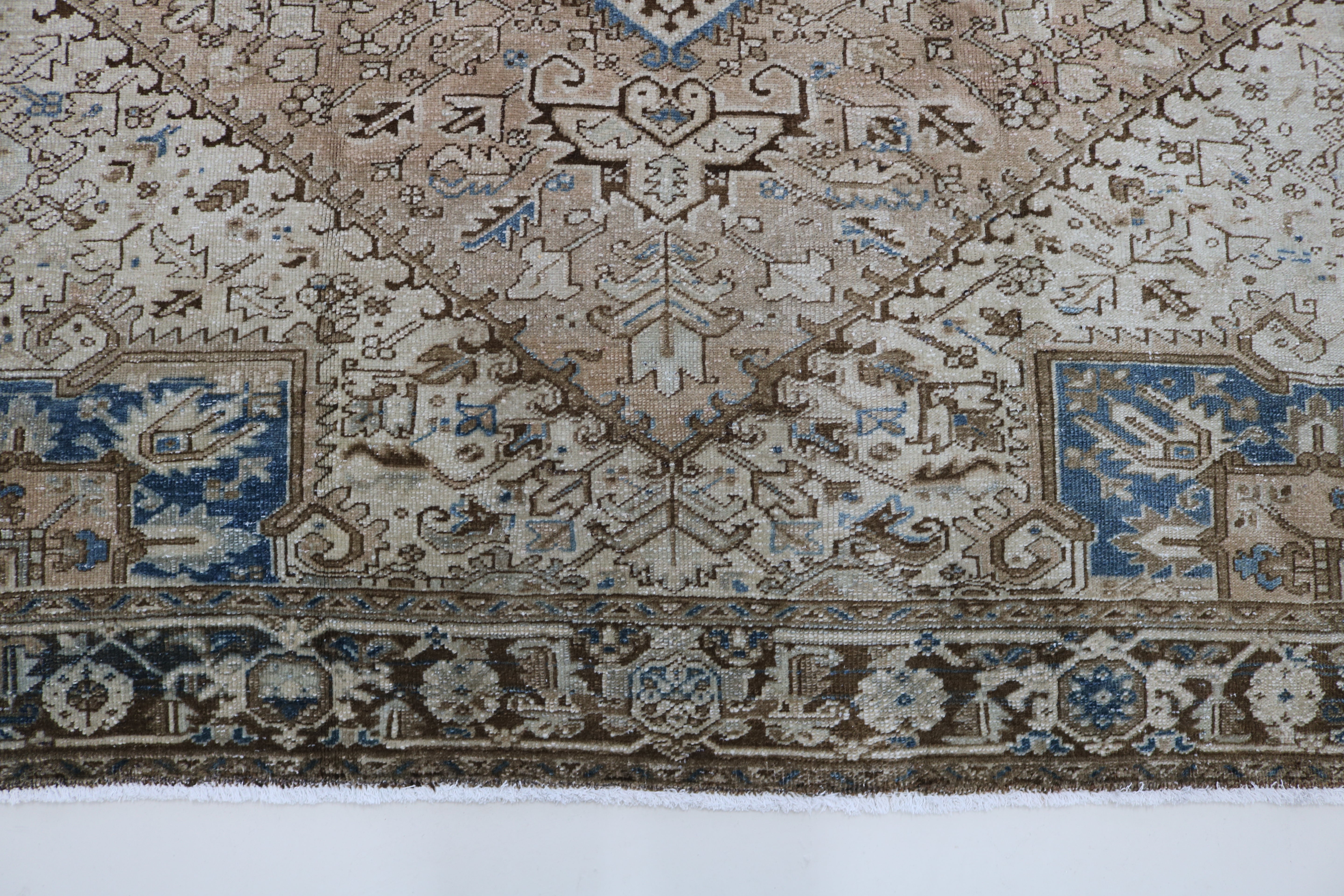 Close-up of hand-knotted wool texture on antique Persian Heriz carpet
