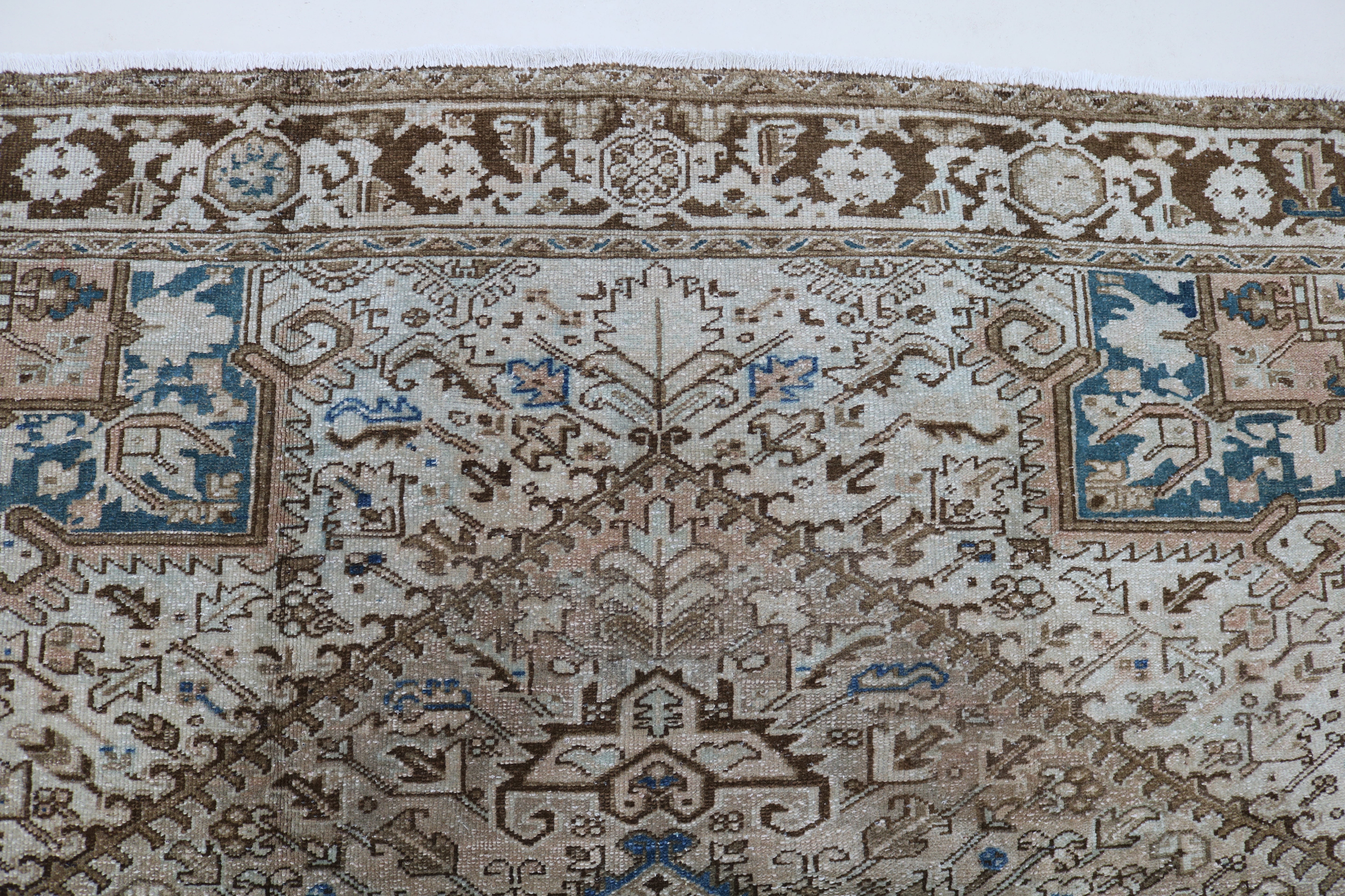 Close-up of hand-knotted wool texture on antique Persian Heriz carpet