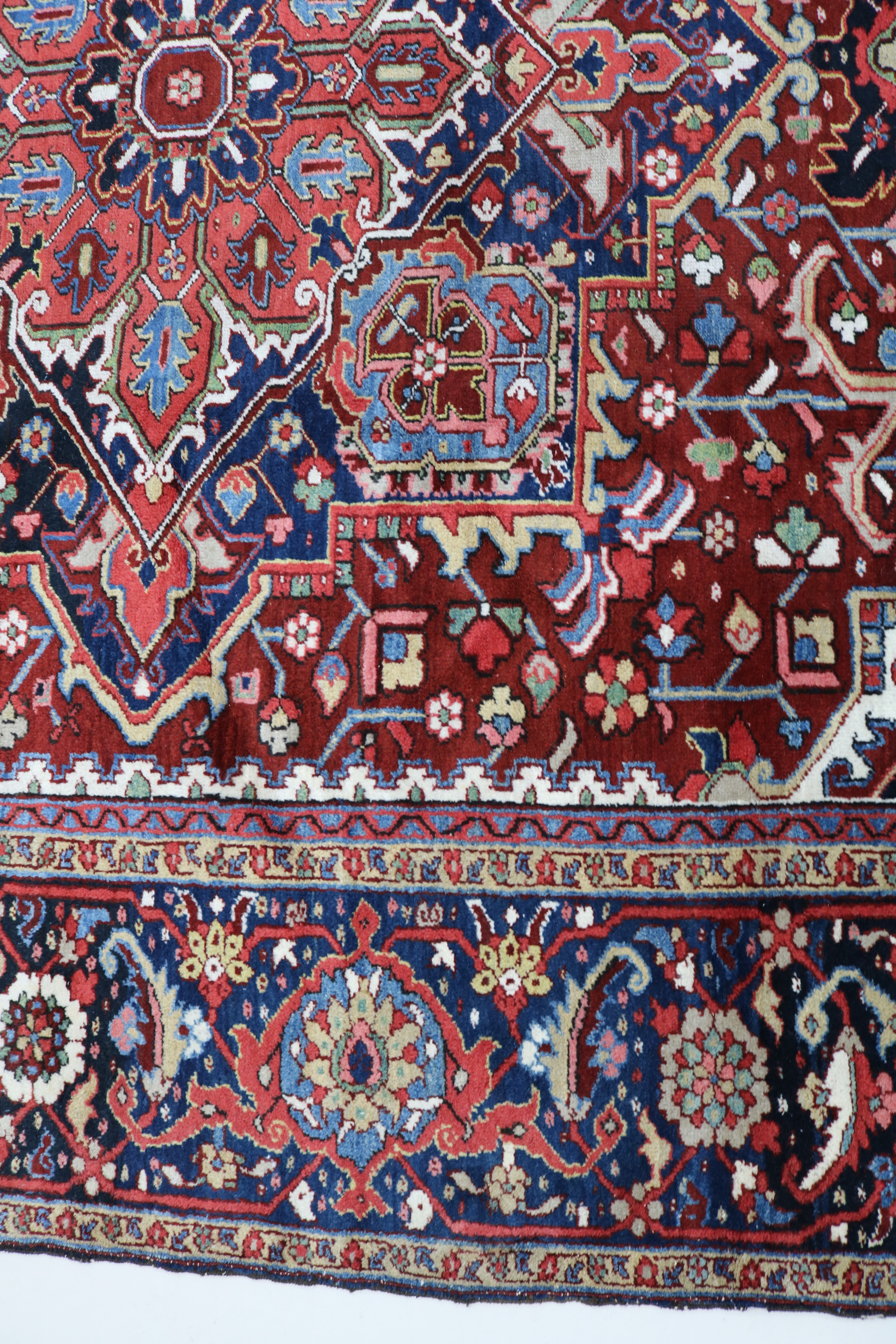 Close-up of hand-knotted wool texture on fine antique Persian Heriz carpet