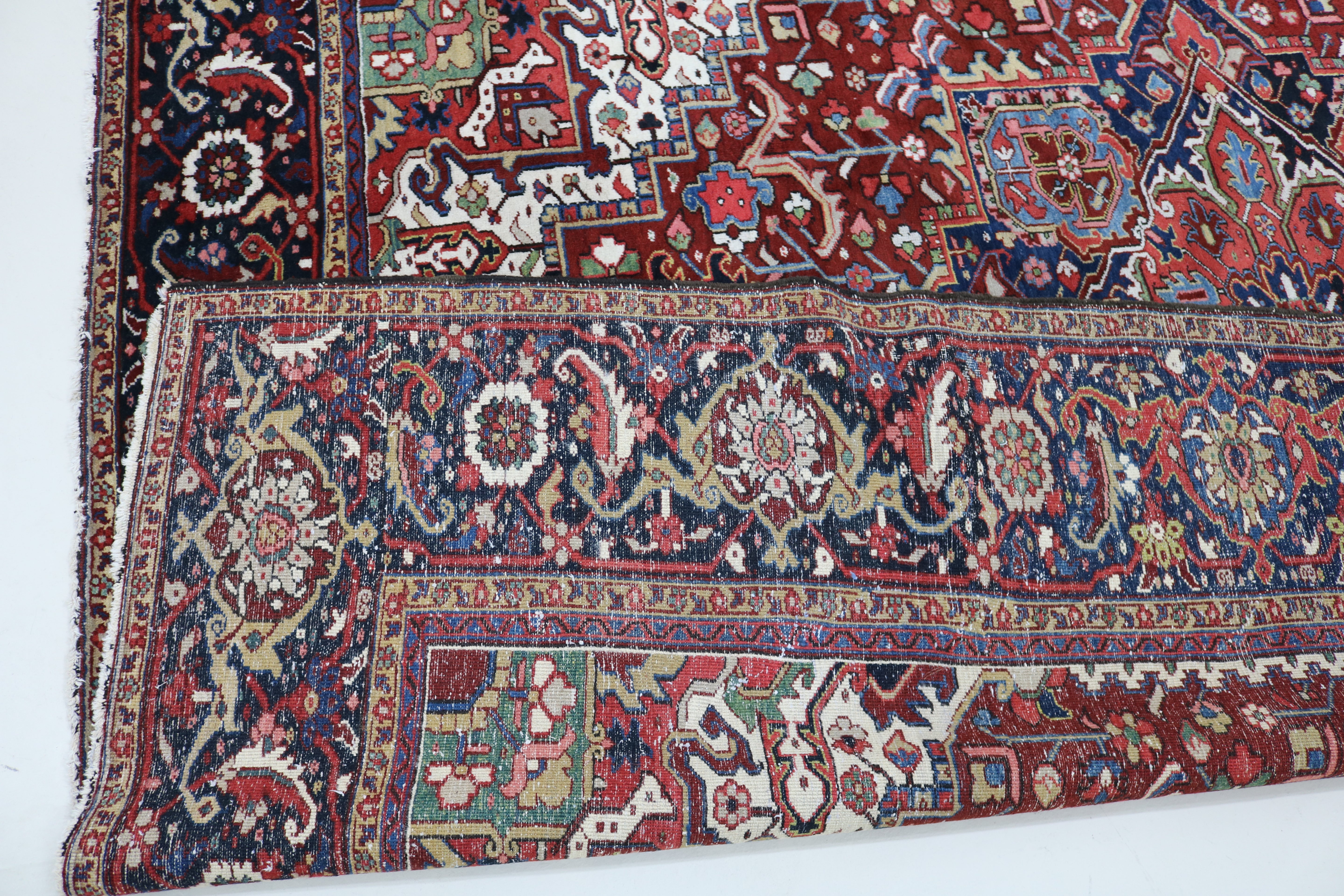 Close-up of hand-knotted wool texture on fine antique Persian Heriz carpet