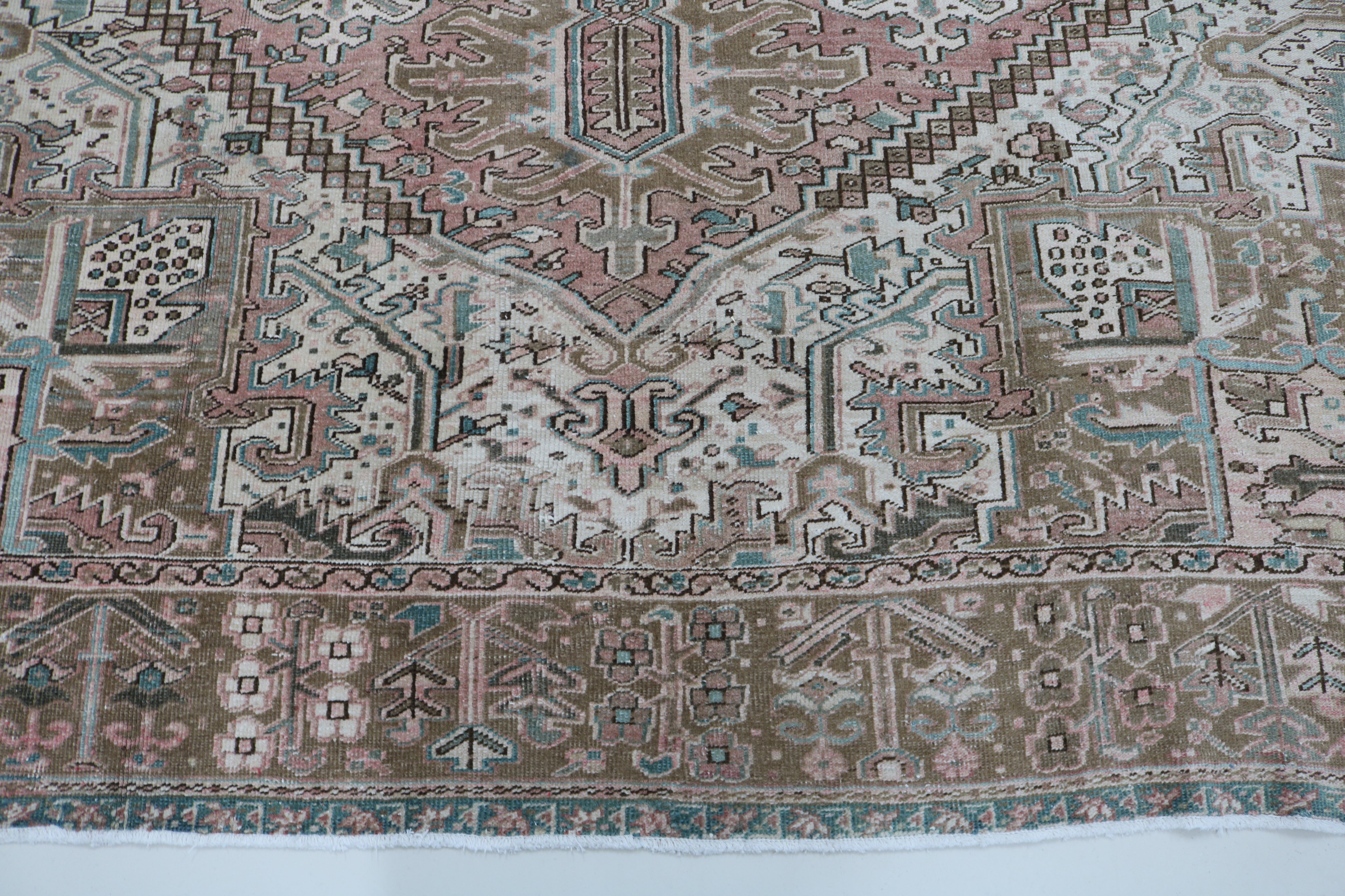 Close-up of hand-knotted wool texture on antique Persian Heriz carpet