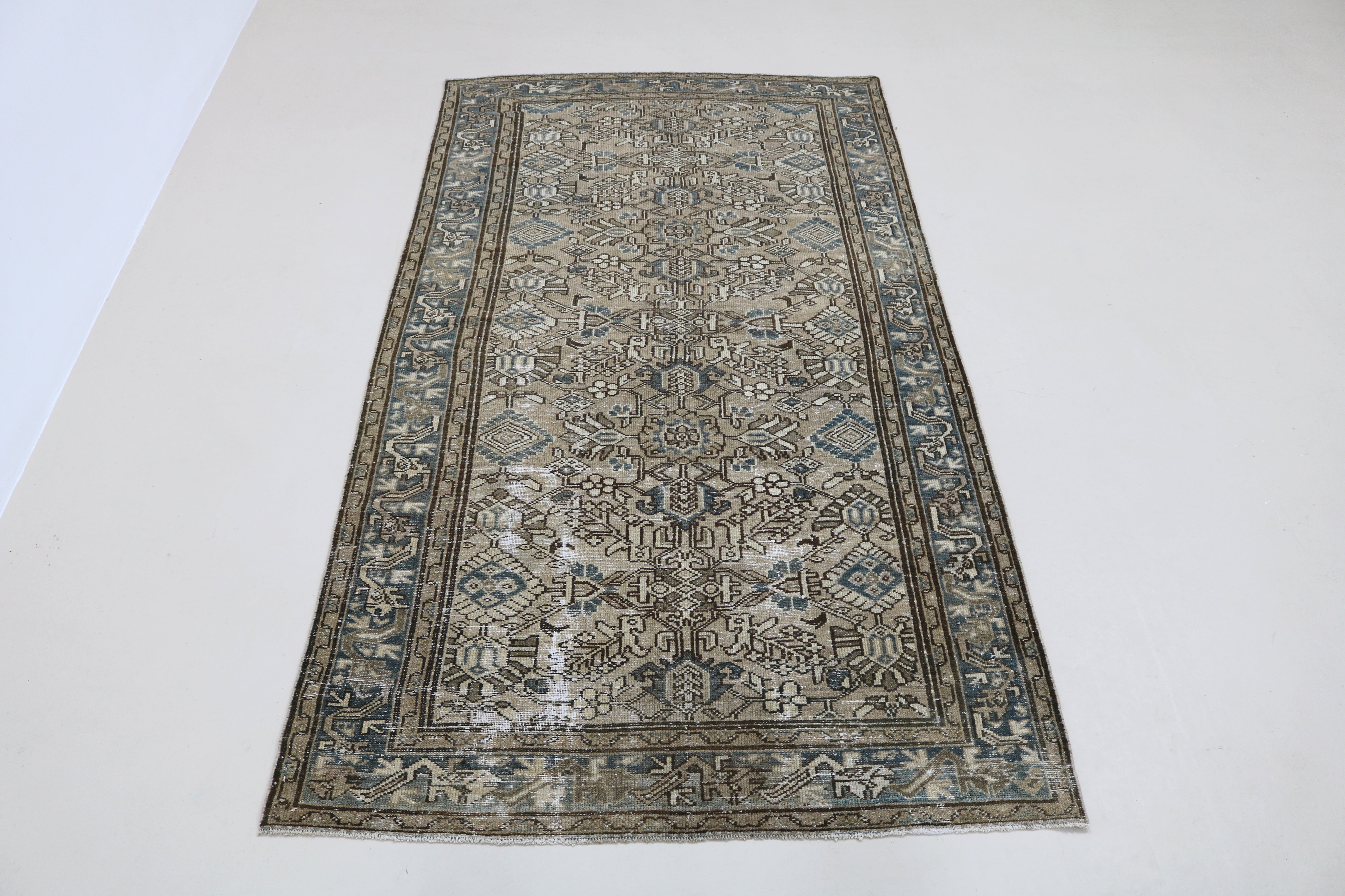 Full view of antique Persian Karaja rug with strong geometric field and traditional borders