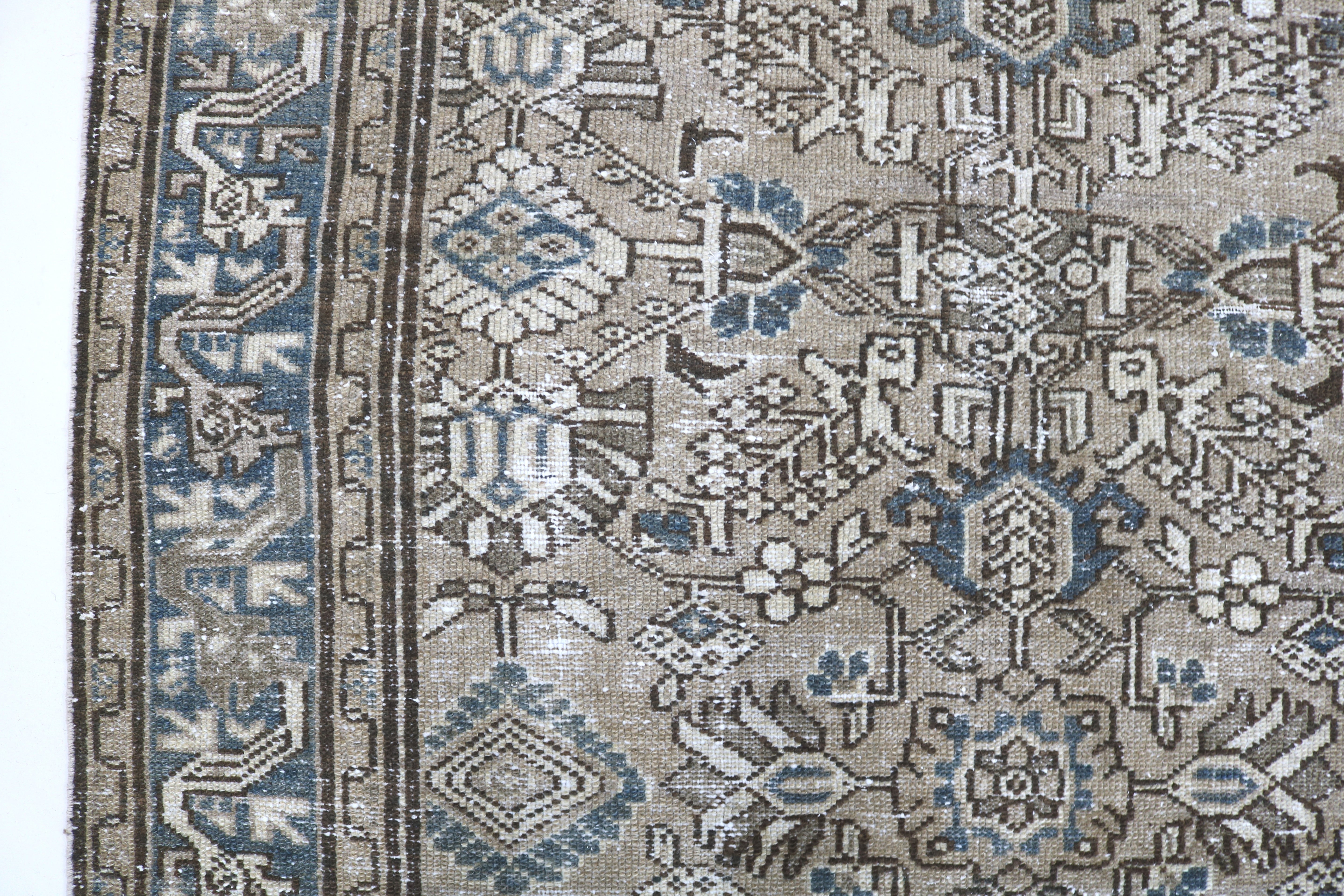 Close-up of hand-knotted wool texture on antique Persian Karaja rug