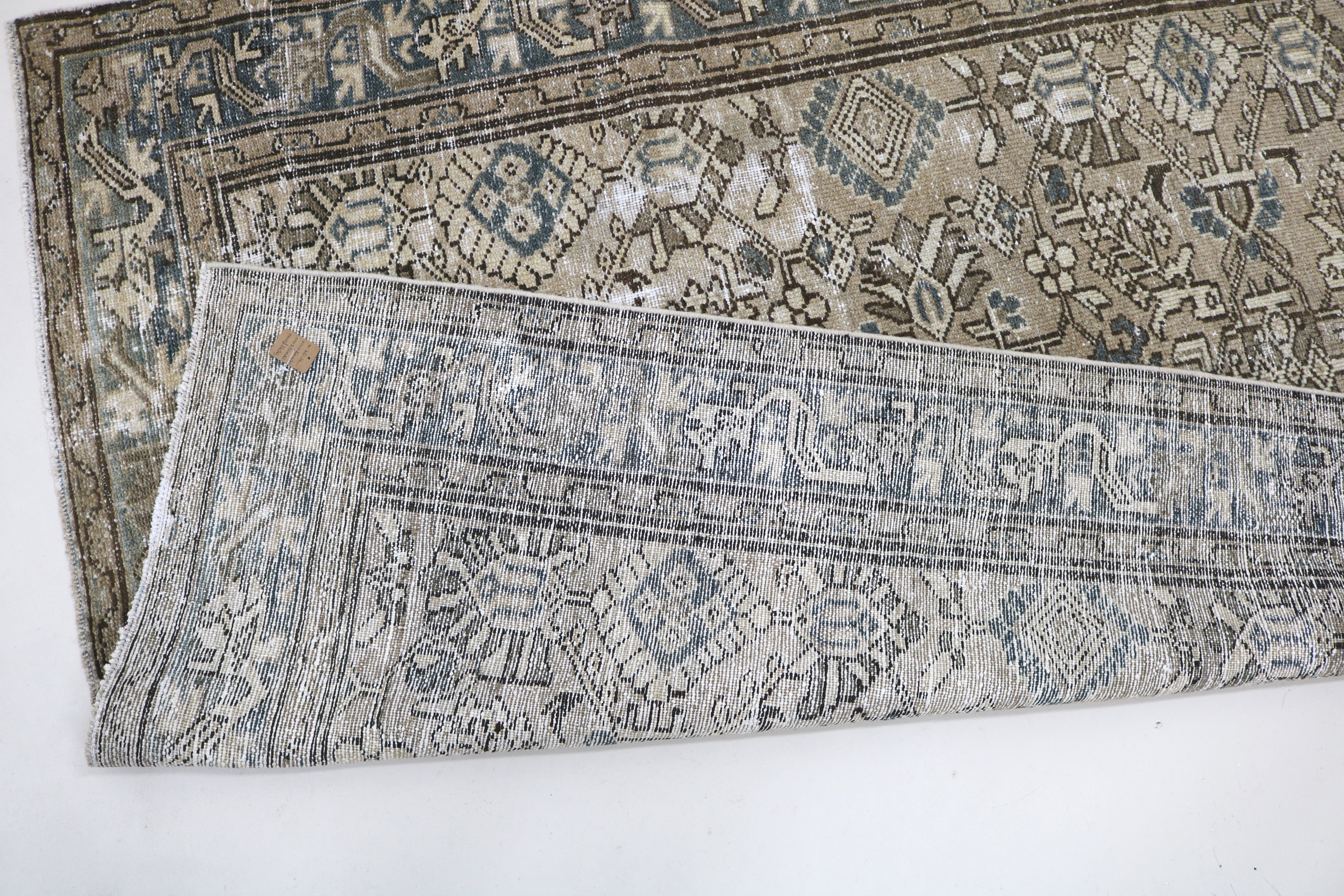 Close-up of hand-knotted wool texture on antique Persian Karaja rug