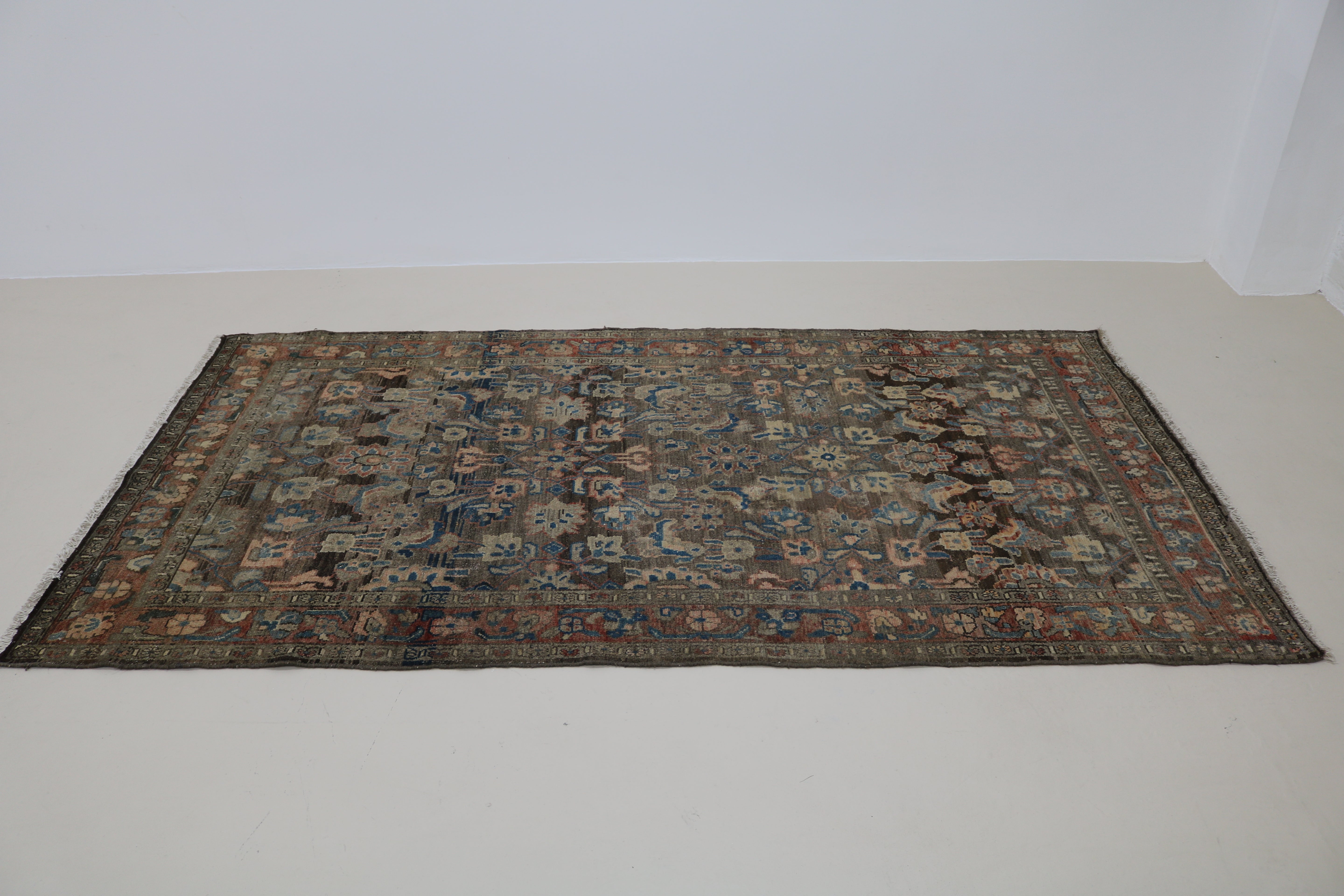 Perspective view of antique Persian Malayer rug laid on floor