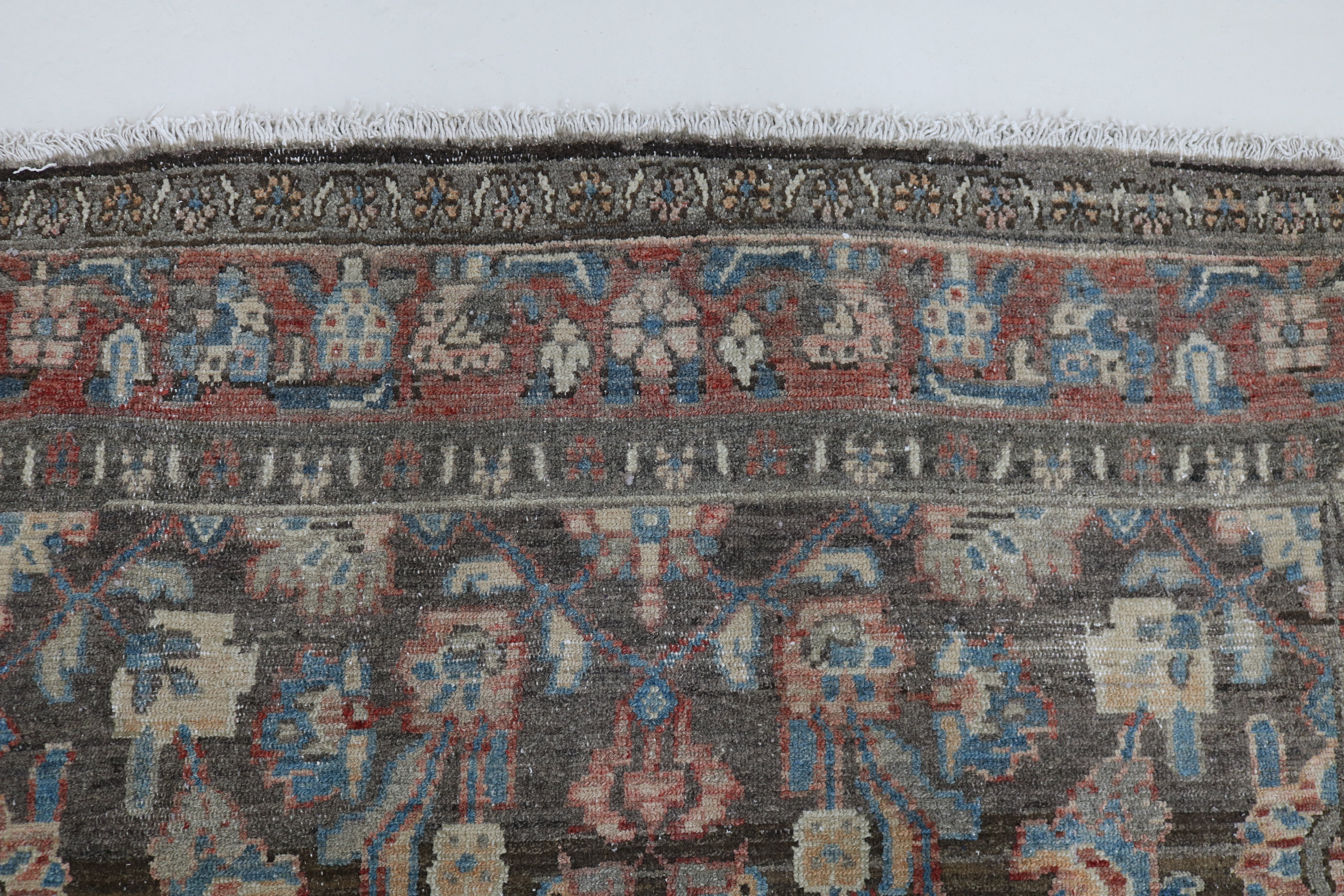 Close-up of hand-knotted wool texture on antique Persian Malayer rug