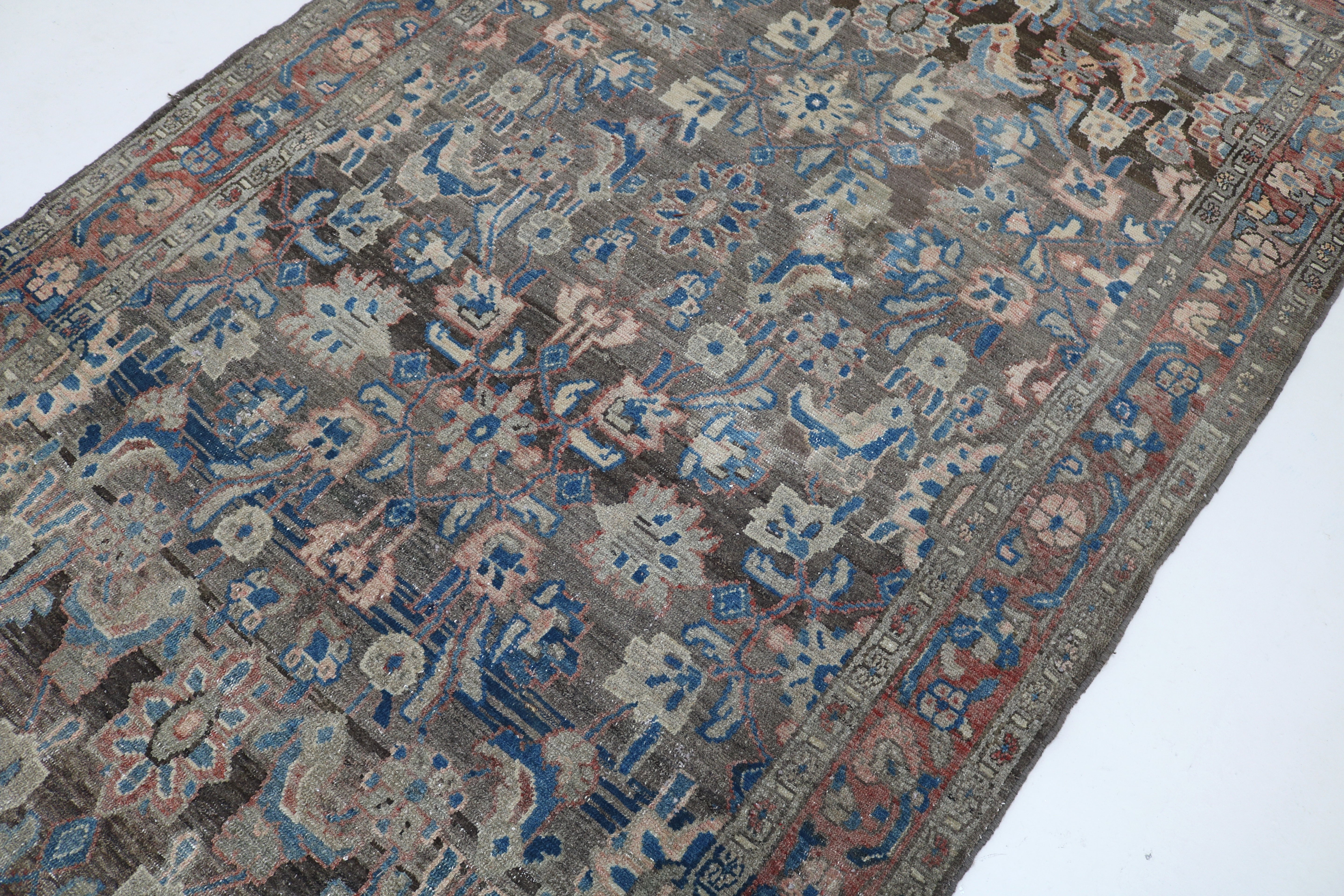 Close-up of hand-knotted wool texture on antique Persian Malayer rug