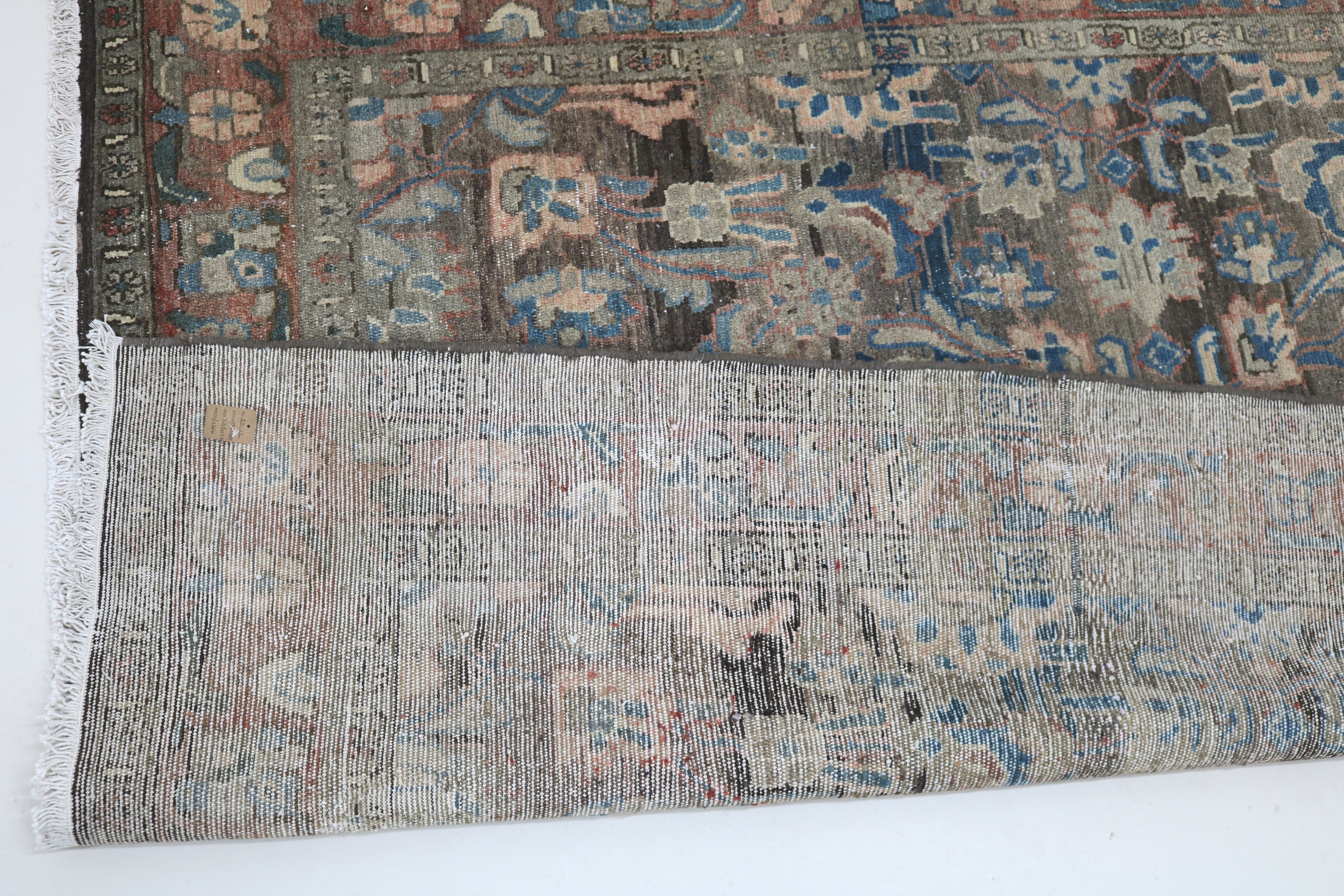 Close-up of hand-knotted wool texture on antique Persian Malayer rug