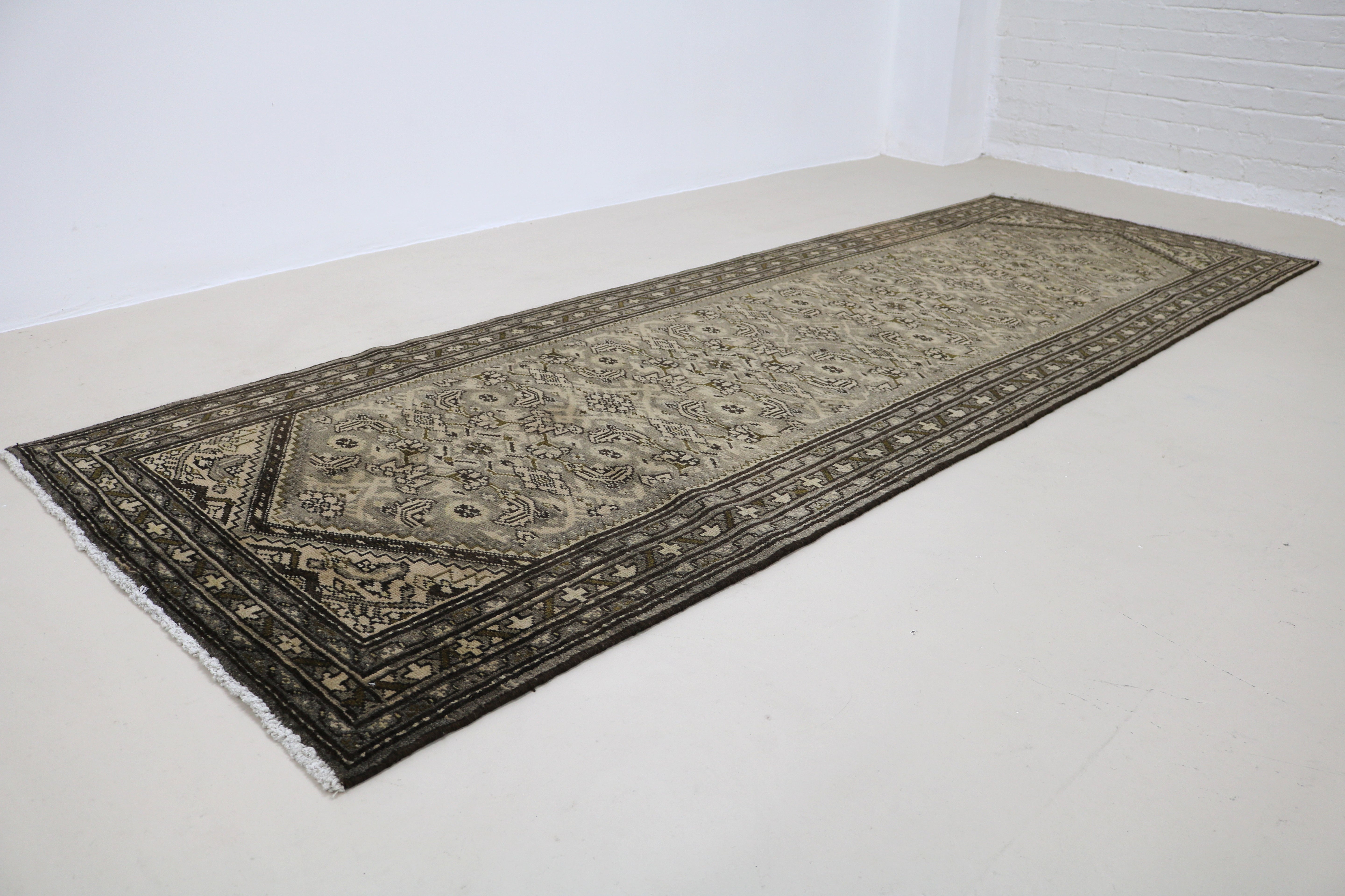 Angled view of vintage Persian Malayer runner showing field and borders