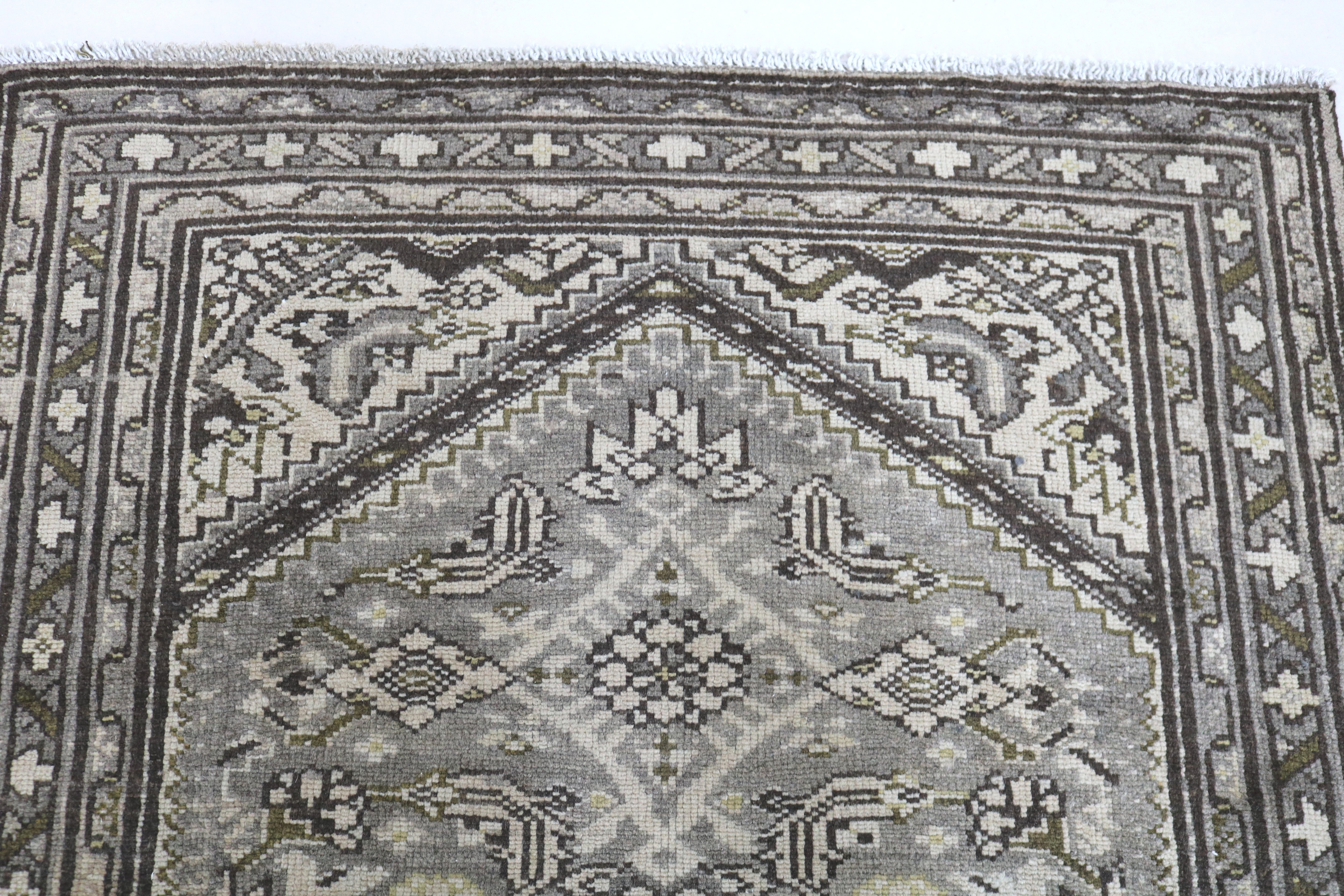 Close-up of end panel detail on vintage Persian Malayer runner