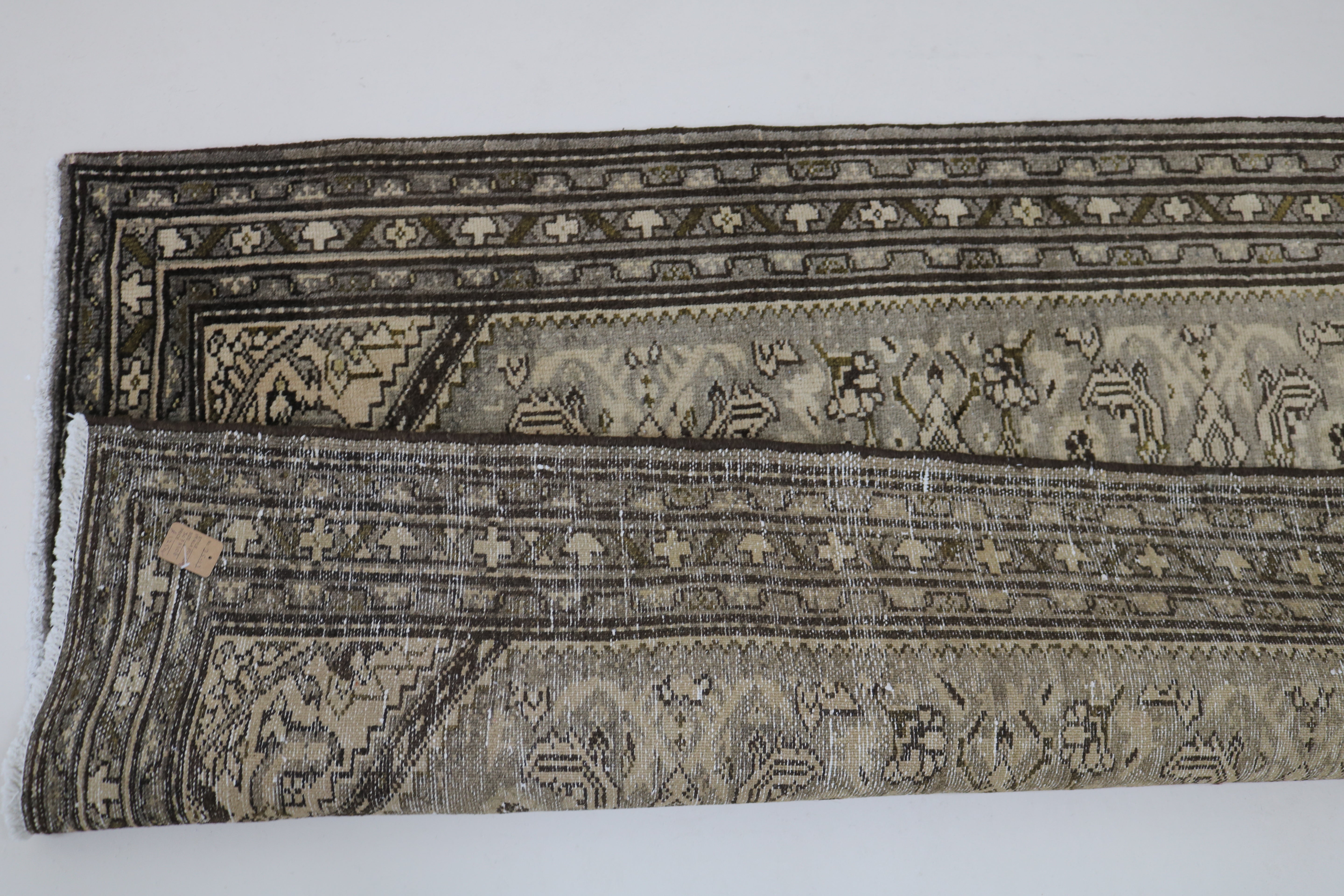 Close-up of hand-knotted wool texture on antique Persian Malayer runner