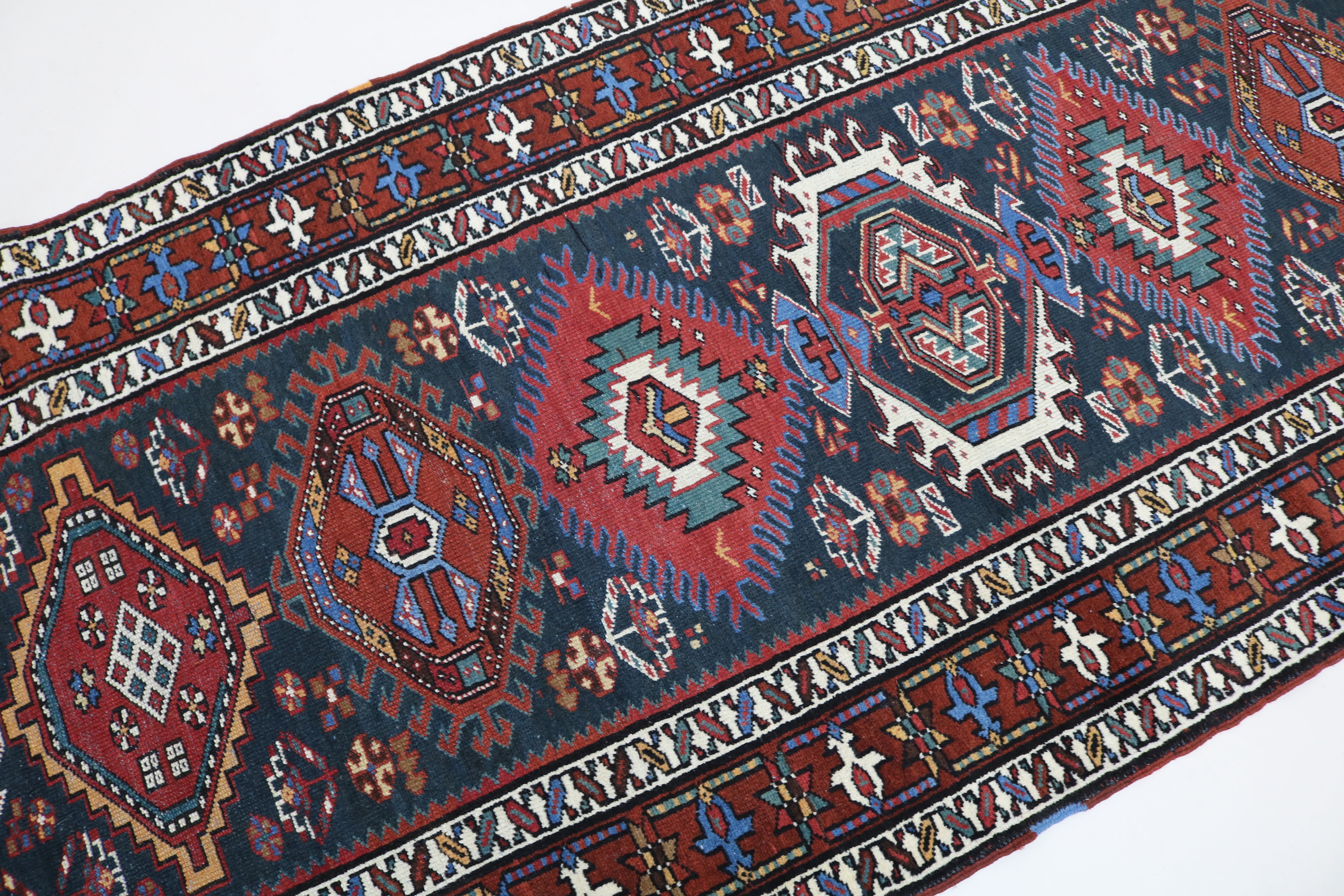 Close-up of hand-knotted wool texture on antique Heriz runner