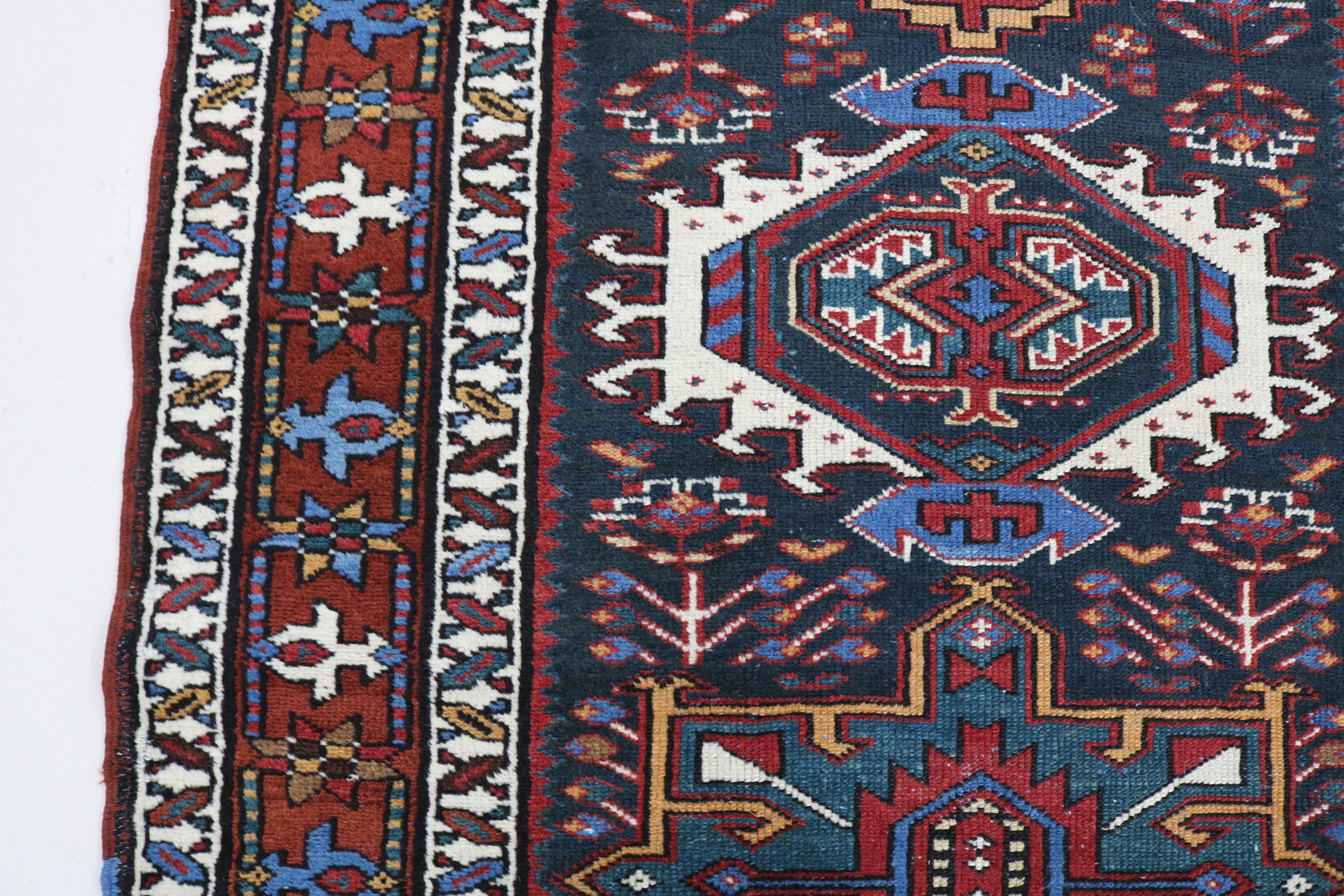 Close-up of hand-knotted wool texture on antique Heriz runner