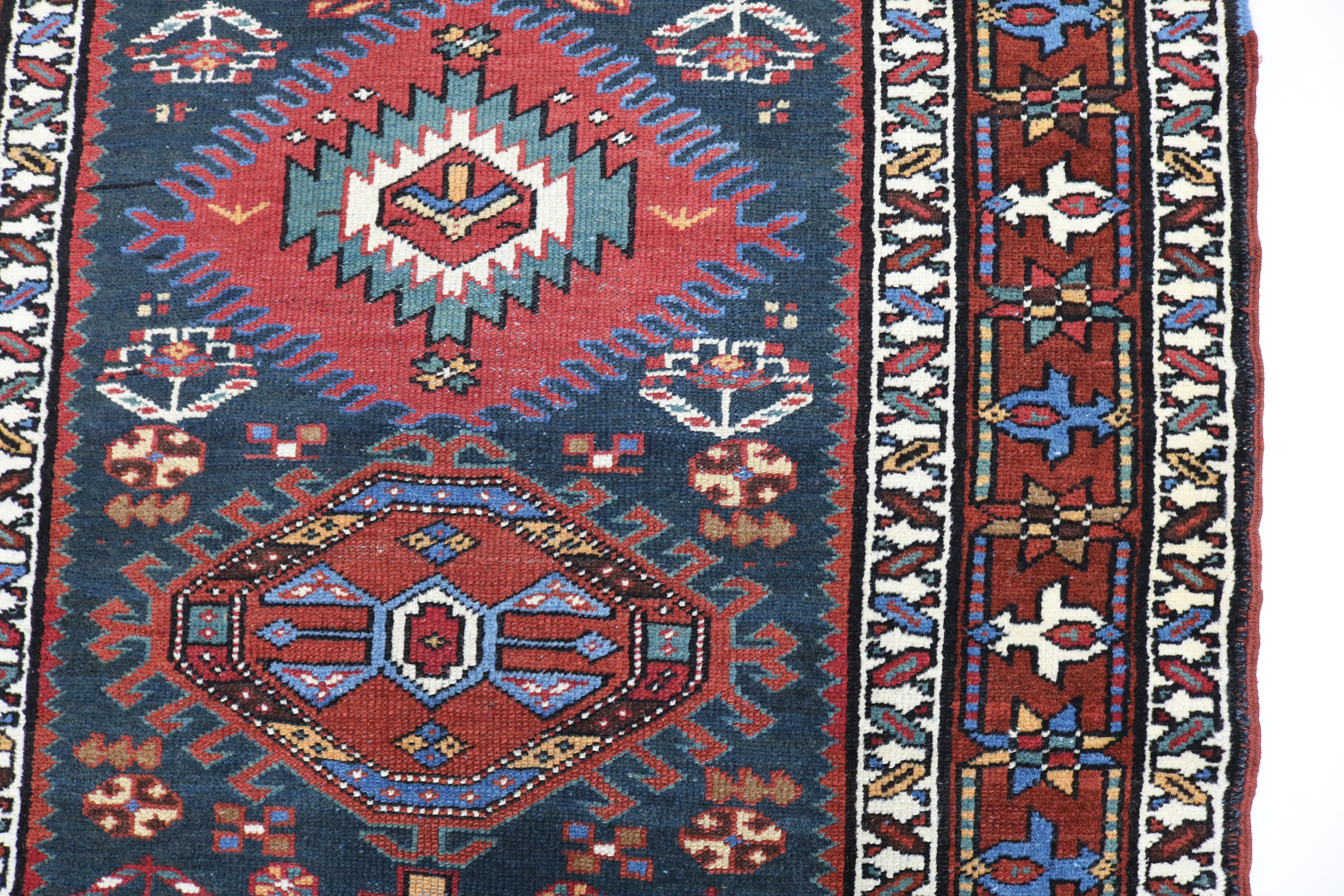 Close-up of hand-knotted wool texture on antique Heriz runner