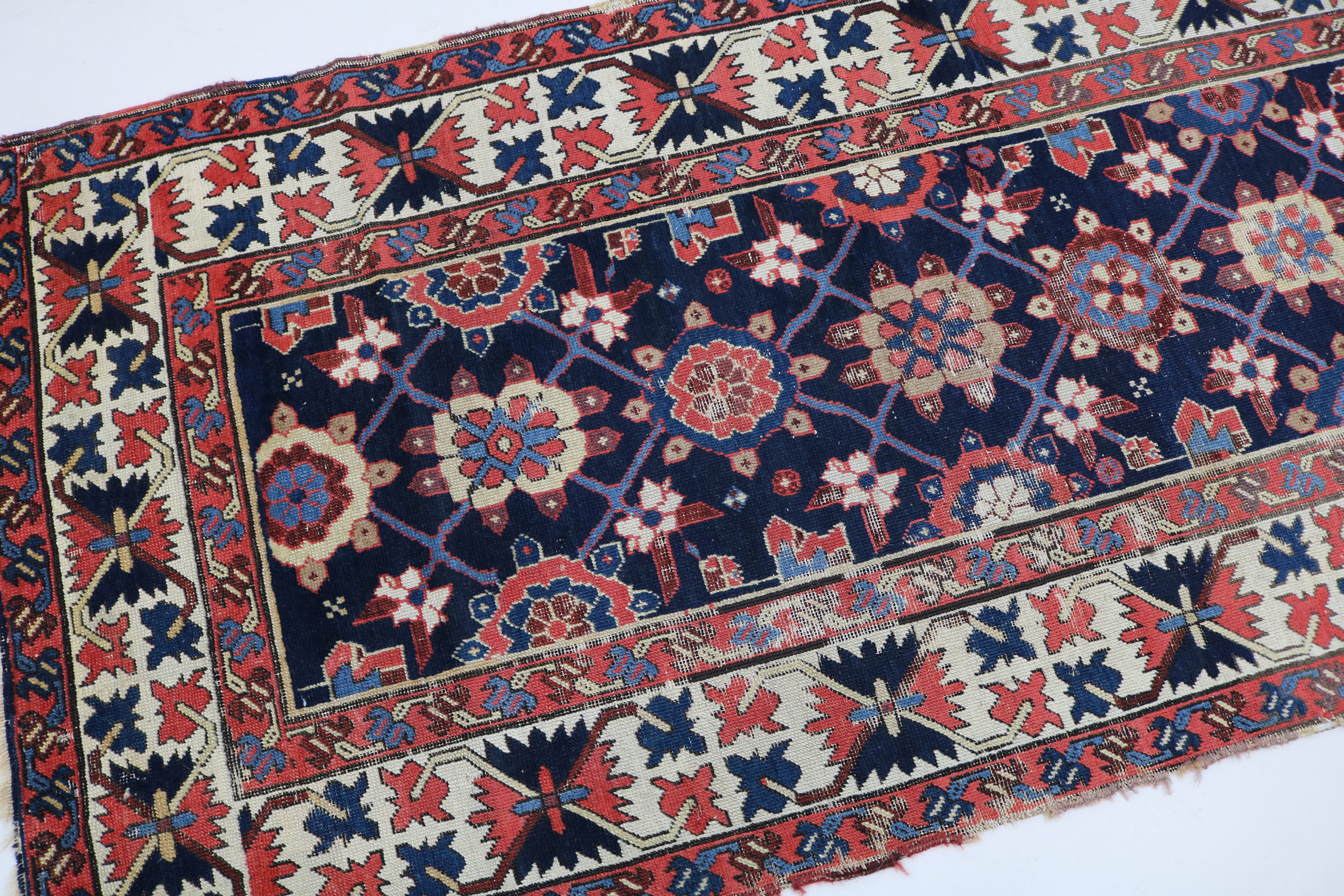 Close-up of hand-knotted wool texture on antique Caucasian Karabag runner