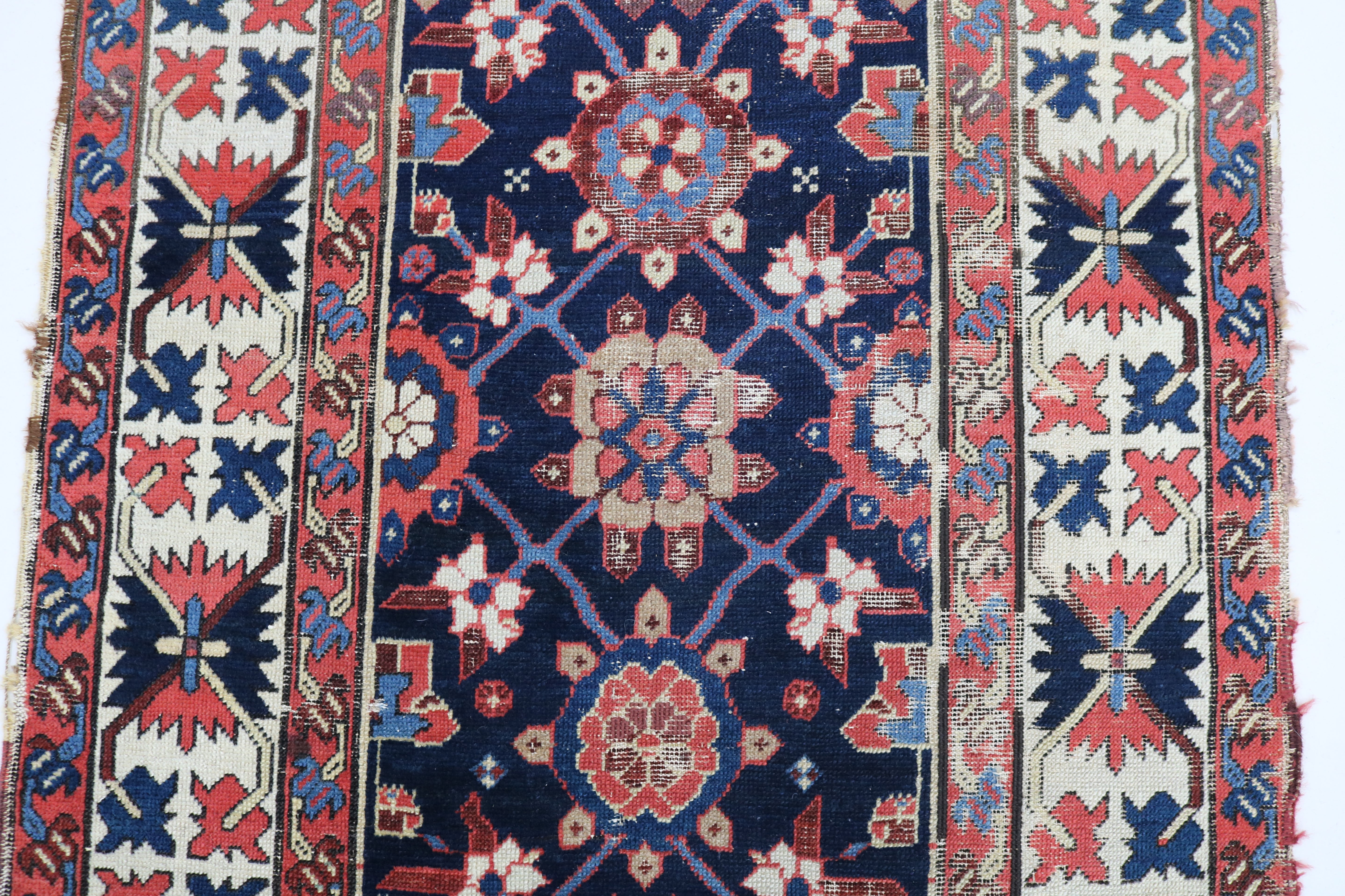 Close-up of hand-knotted wool texture on antique Caucasian Karabag runner