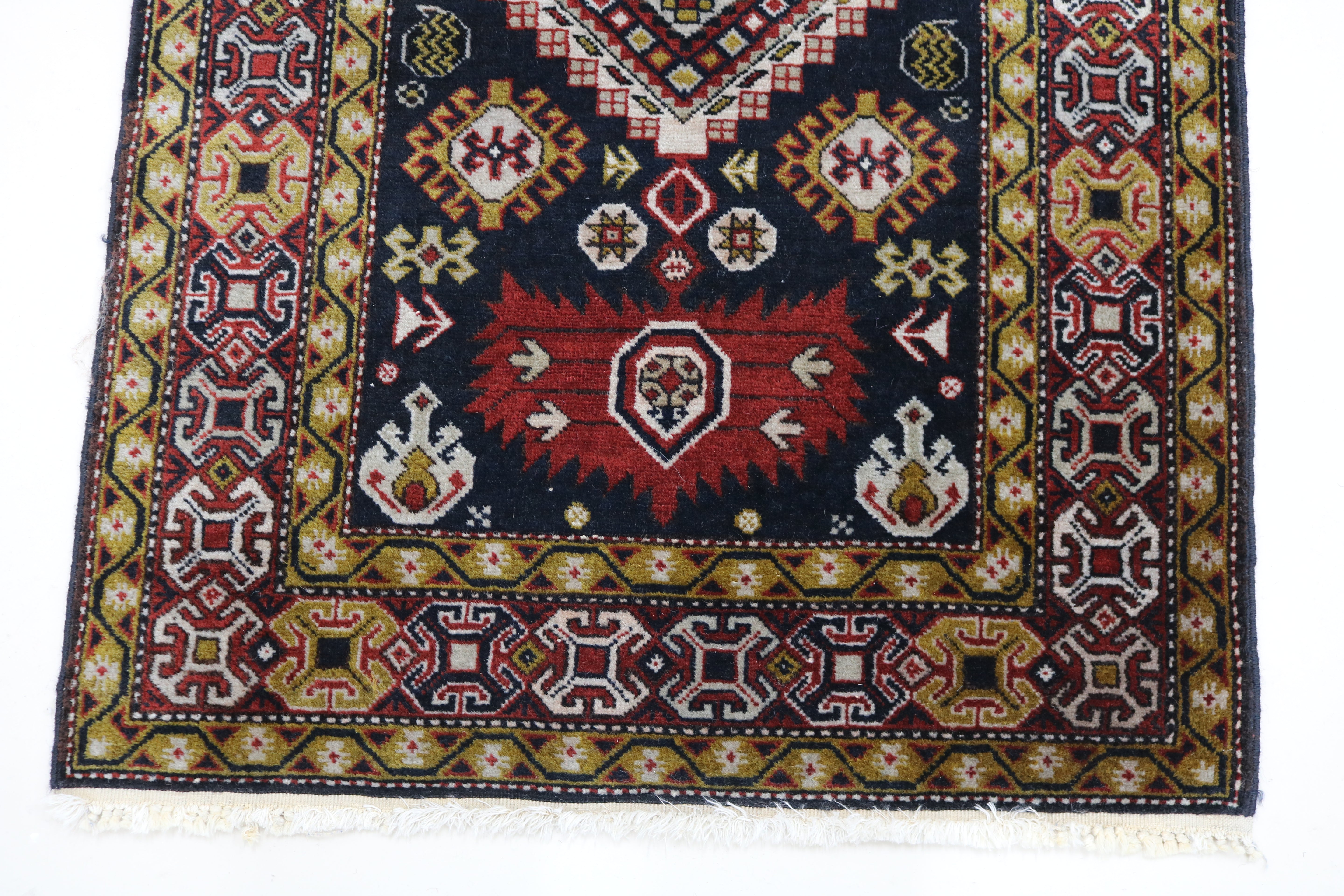 Close-up of hand-knotted wool texture on antique Caucasian Irawan runner