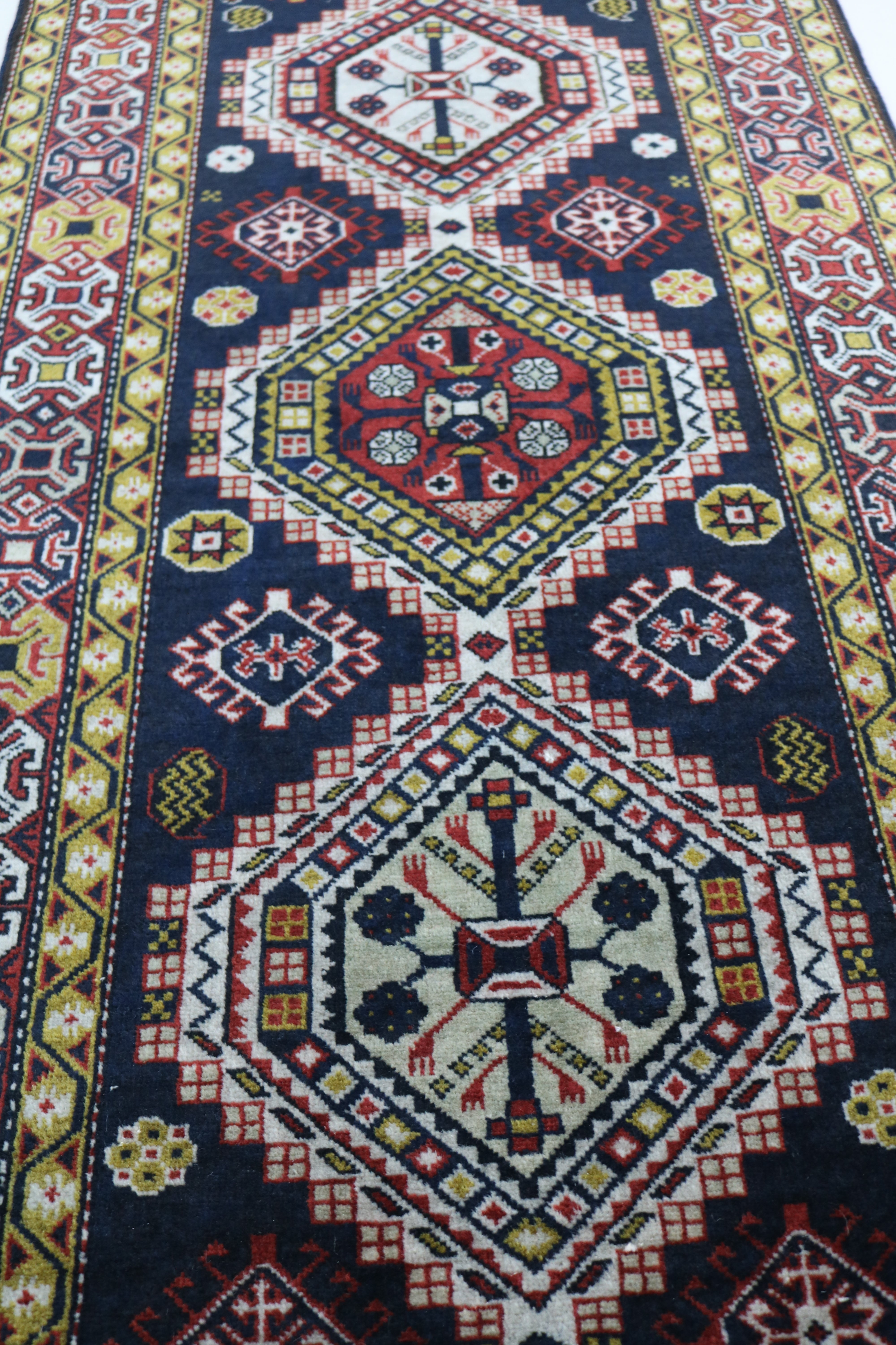 Close-up of hand-knotted wool texture on antique Caucasian Irawan runner