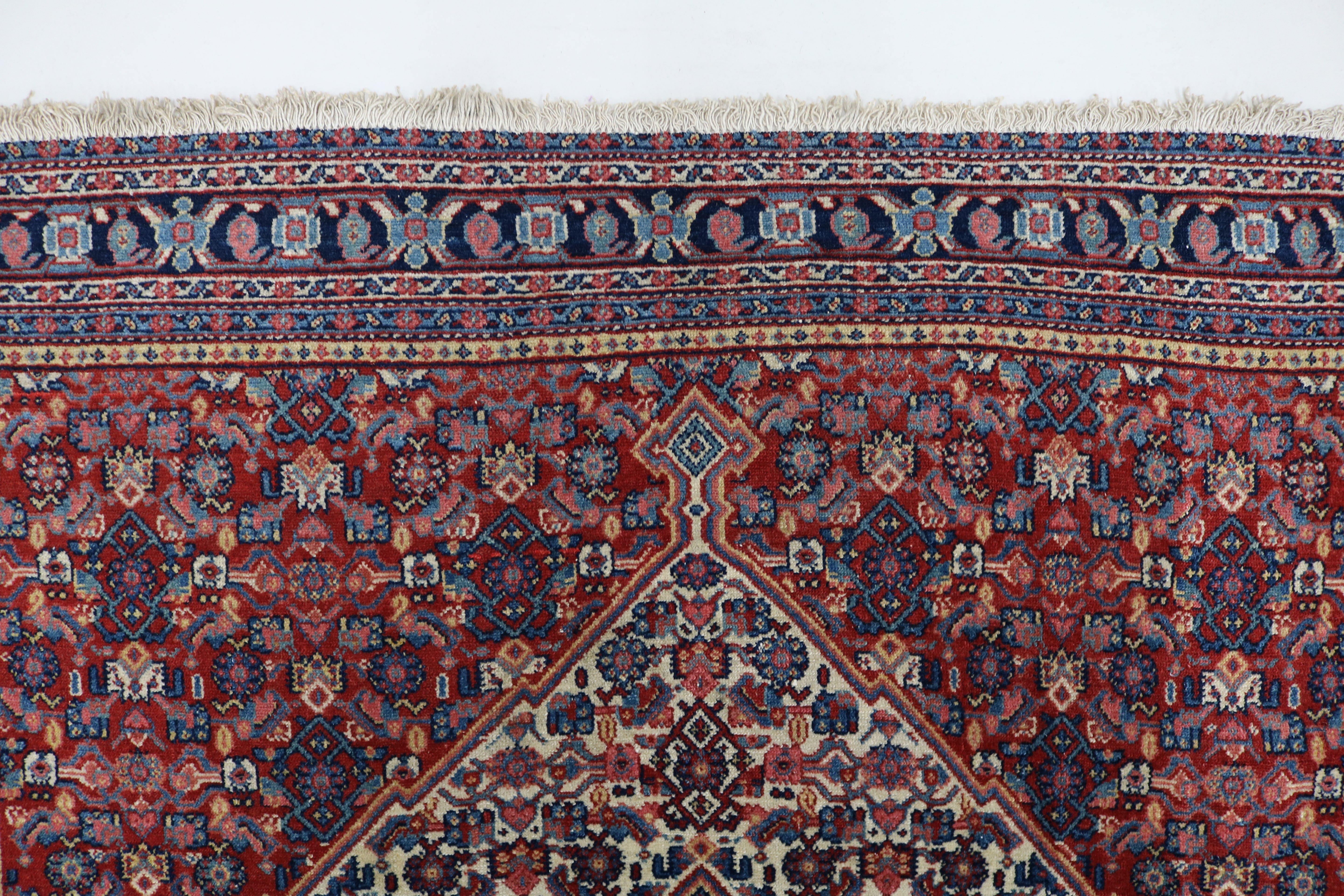 Close-up of finely woven wool texture on antique Persian Senneh rug