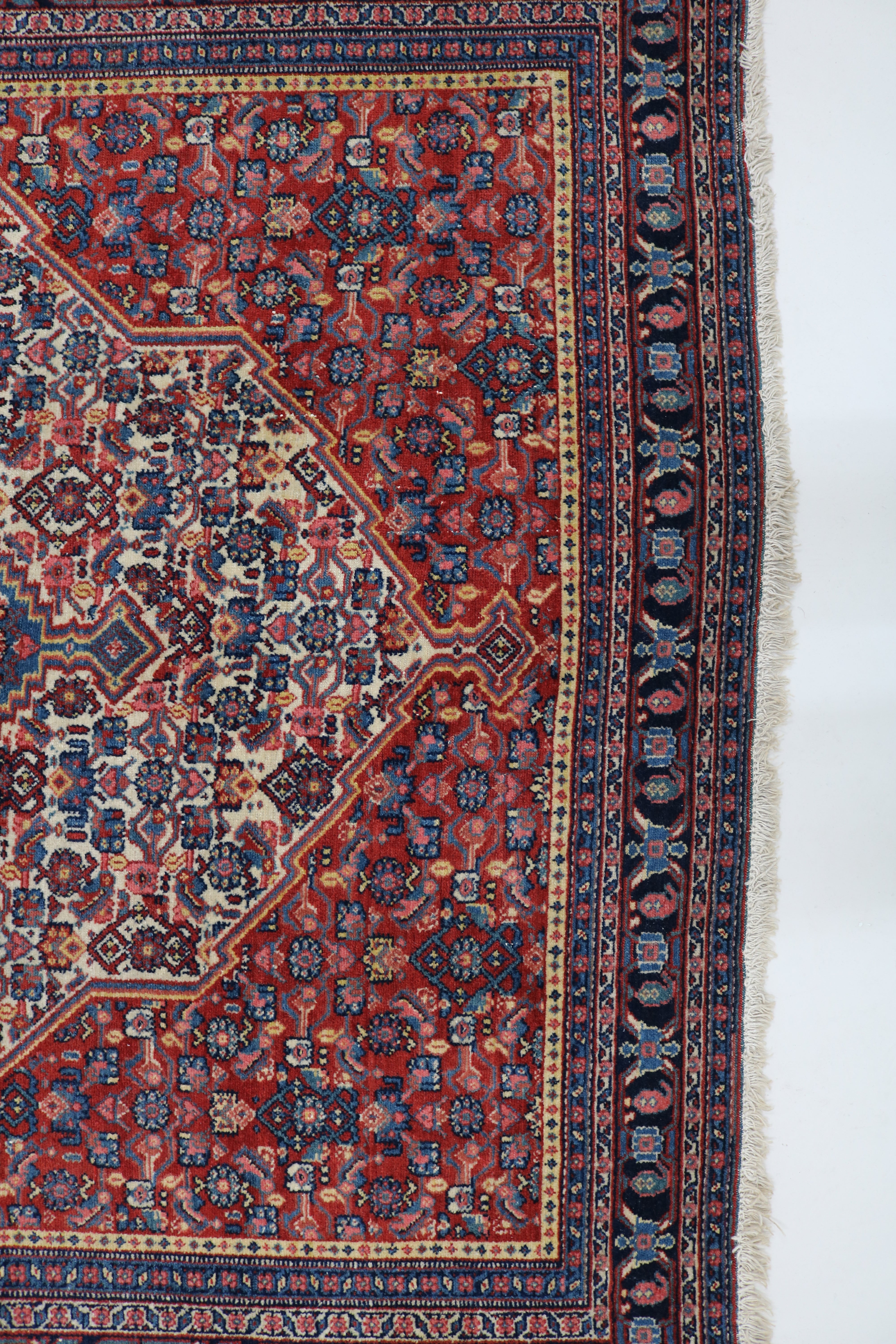 Close-up of finely woven wool texture on antique Persian Senneh rug