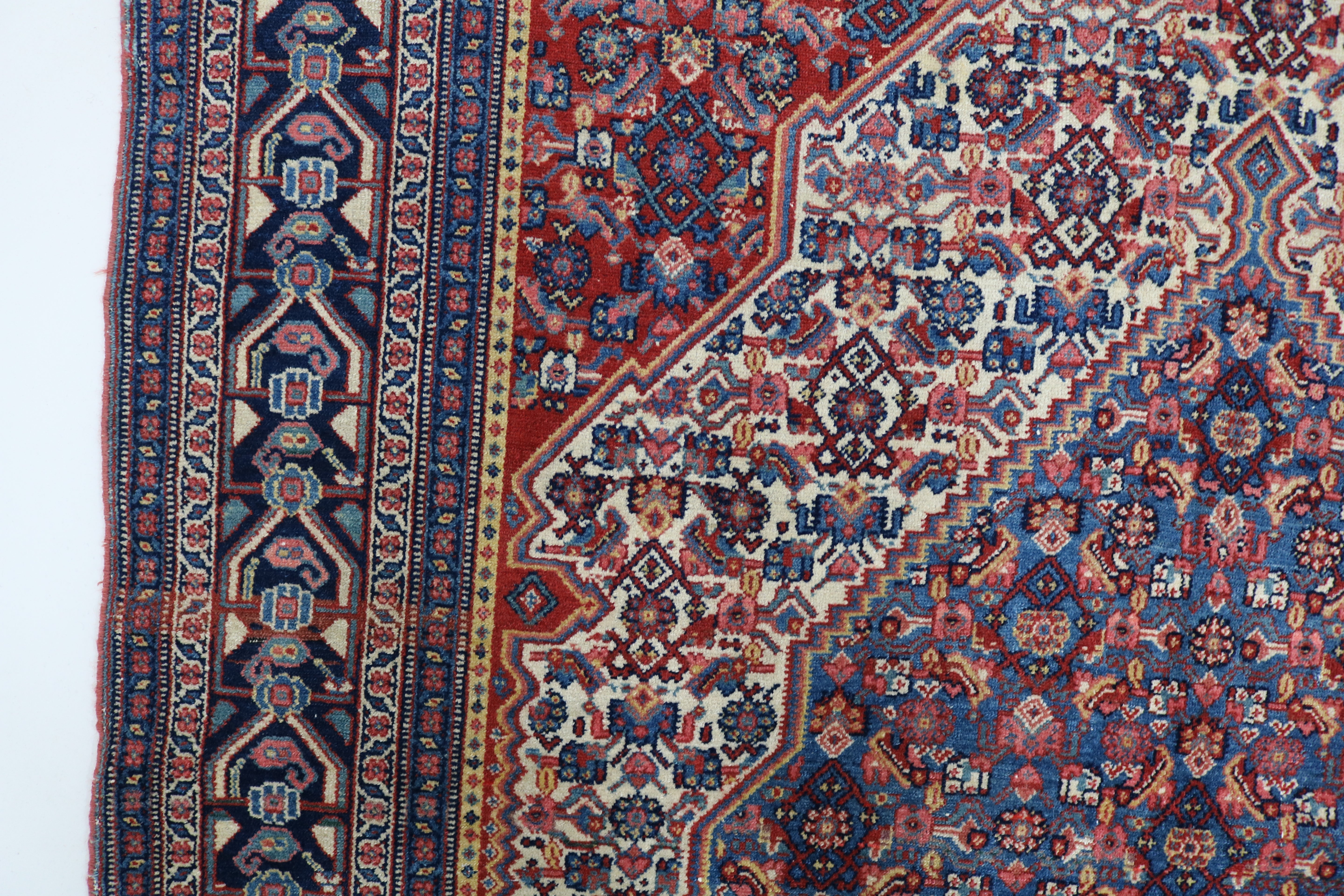 Close-up of finely woven wool texture on antique Persian Senneh rug