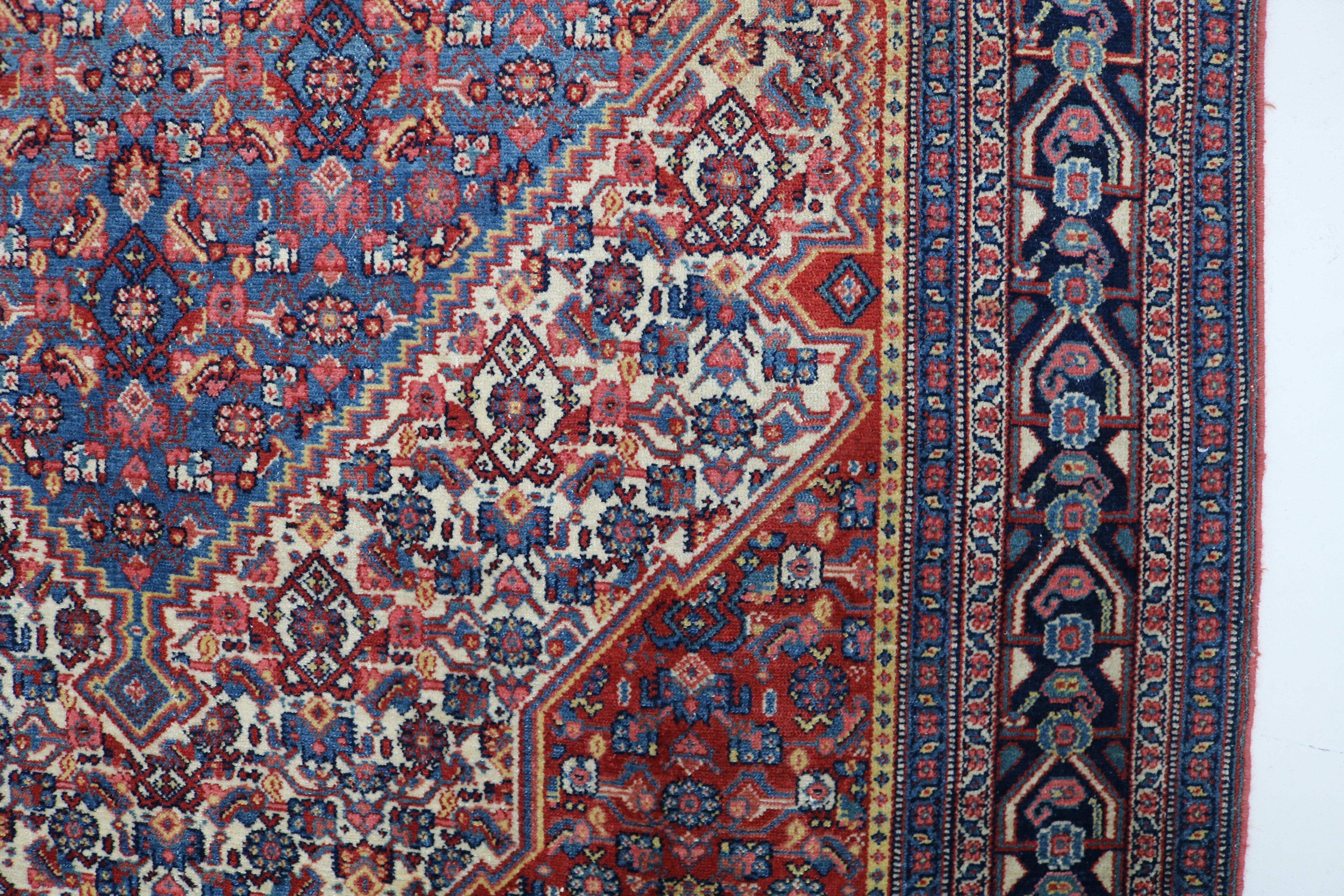 Close-up of finely woven wool texture on antique Persian Senneh rug