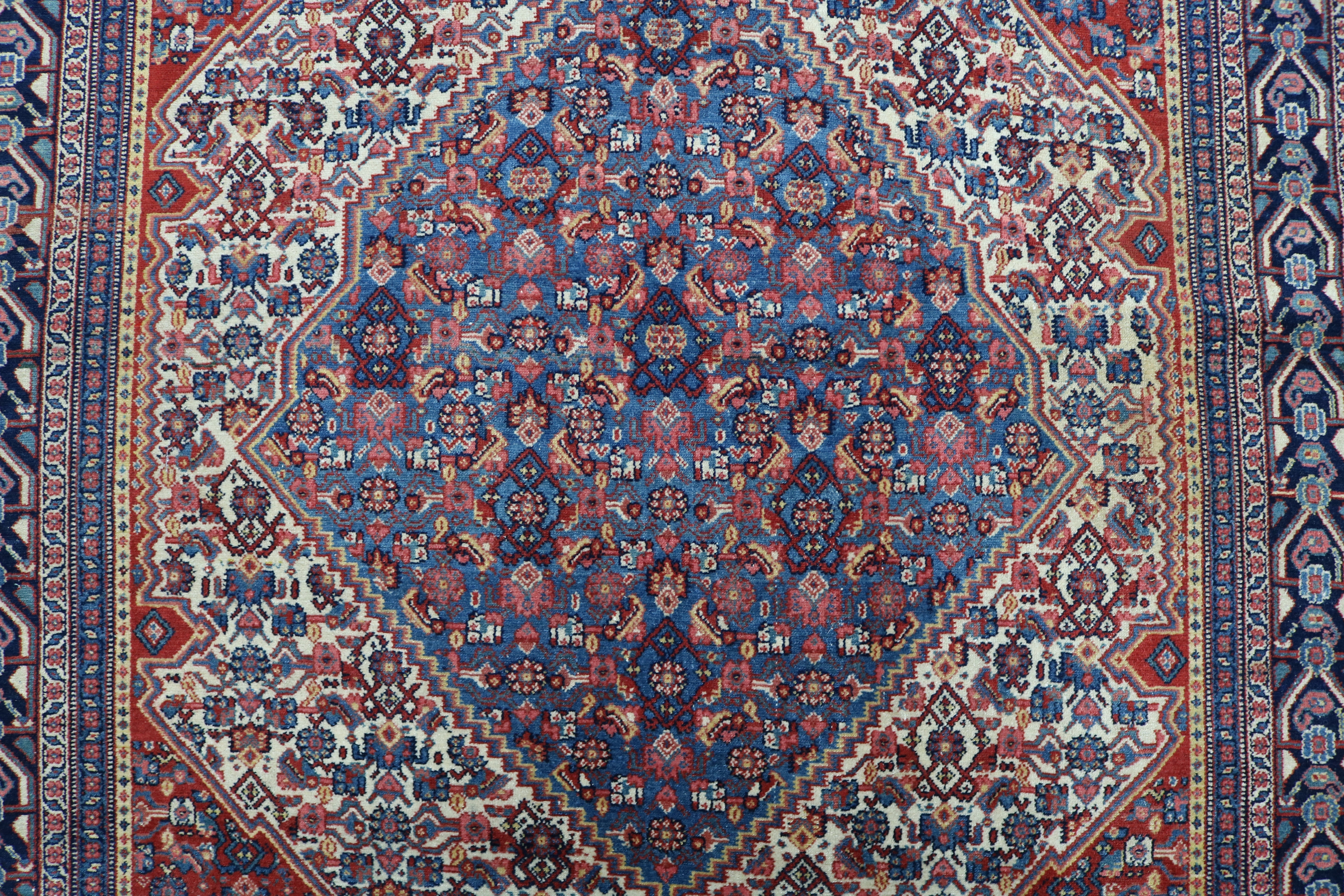Close-up of finely woven wool texture on antique Persian Senneh rug