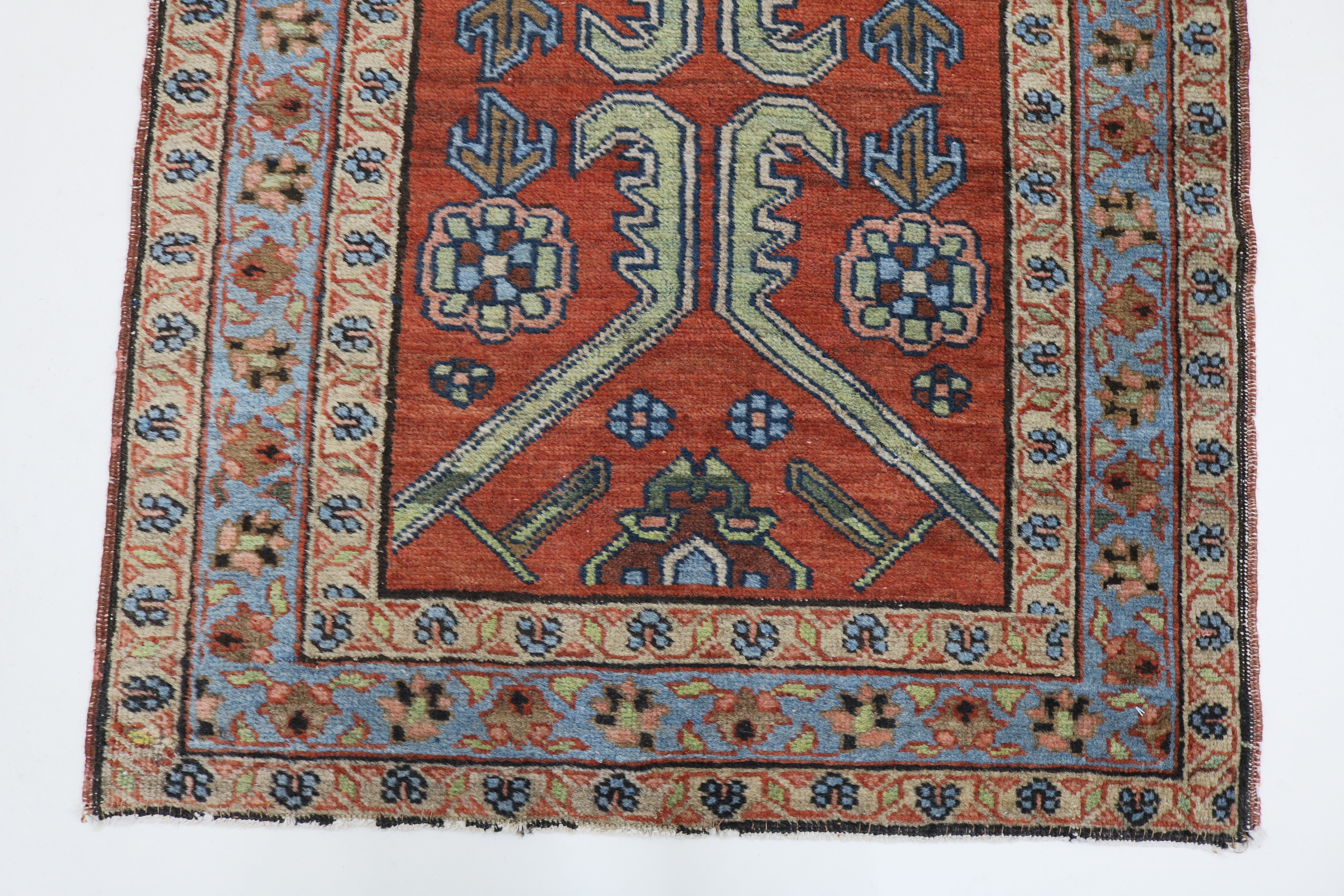 Close-up of hand-knotted wool texture on antique Persian Heriz rug
