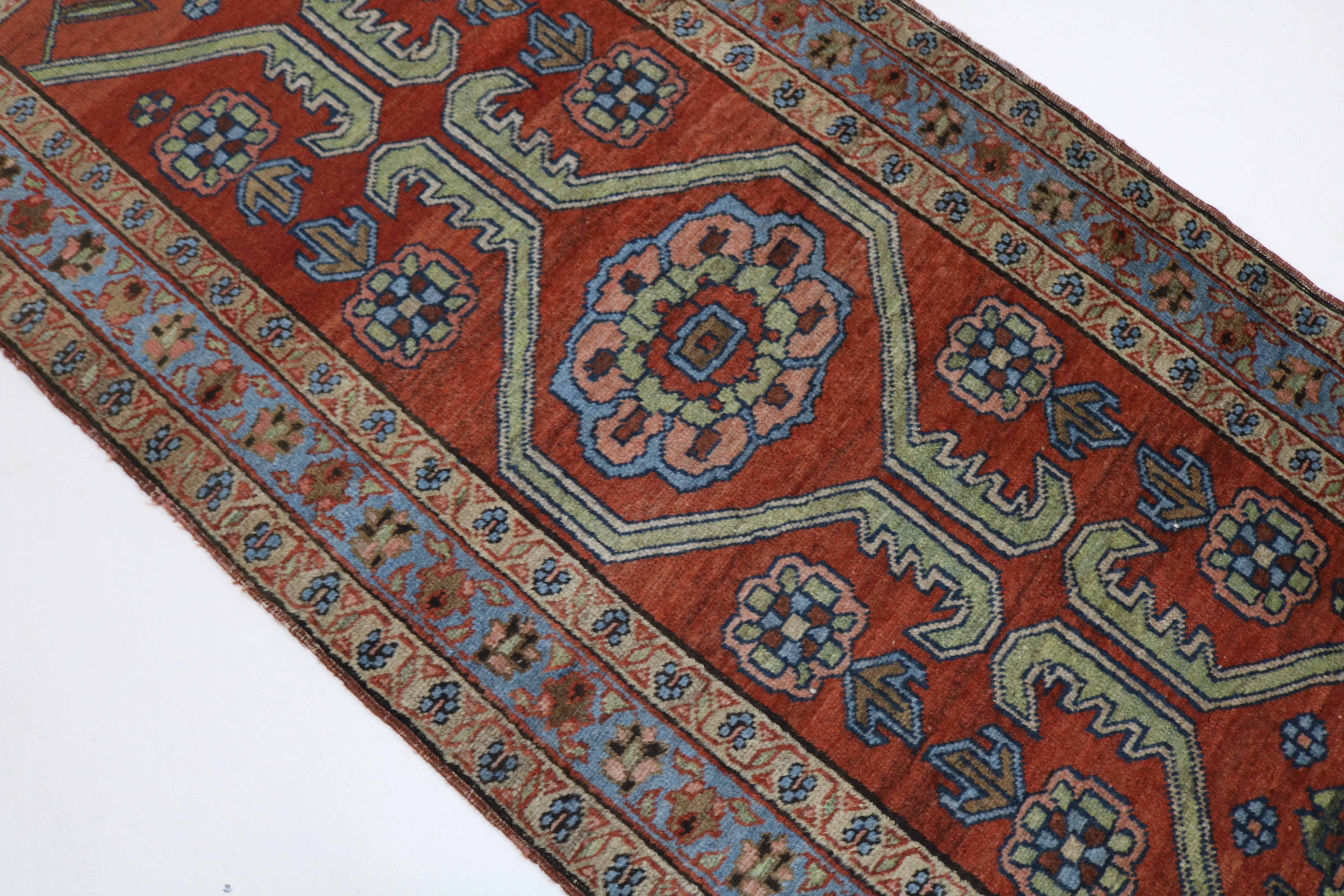 Close-up of hand-knotted wool texture on antique Persian Heriz rug