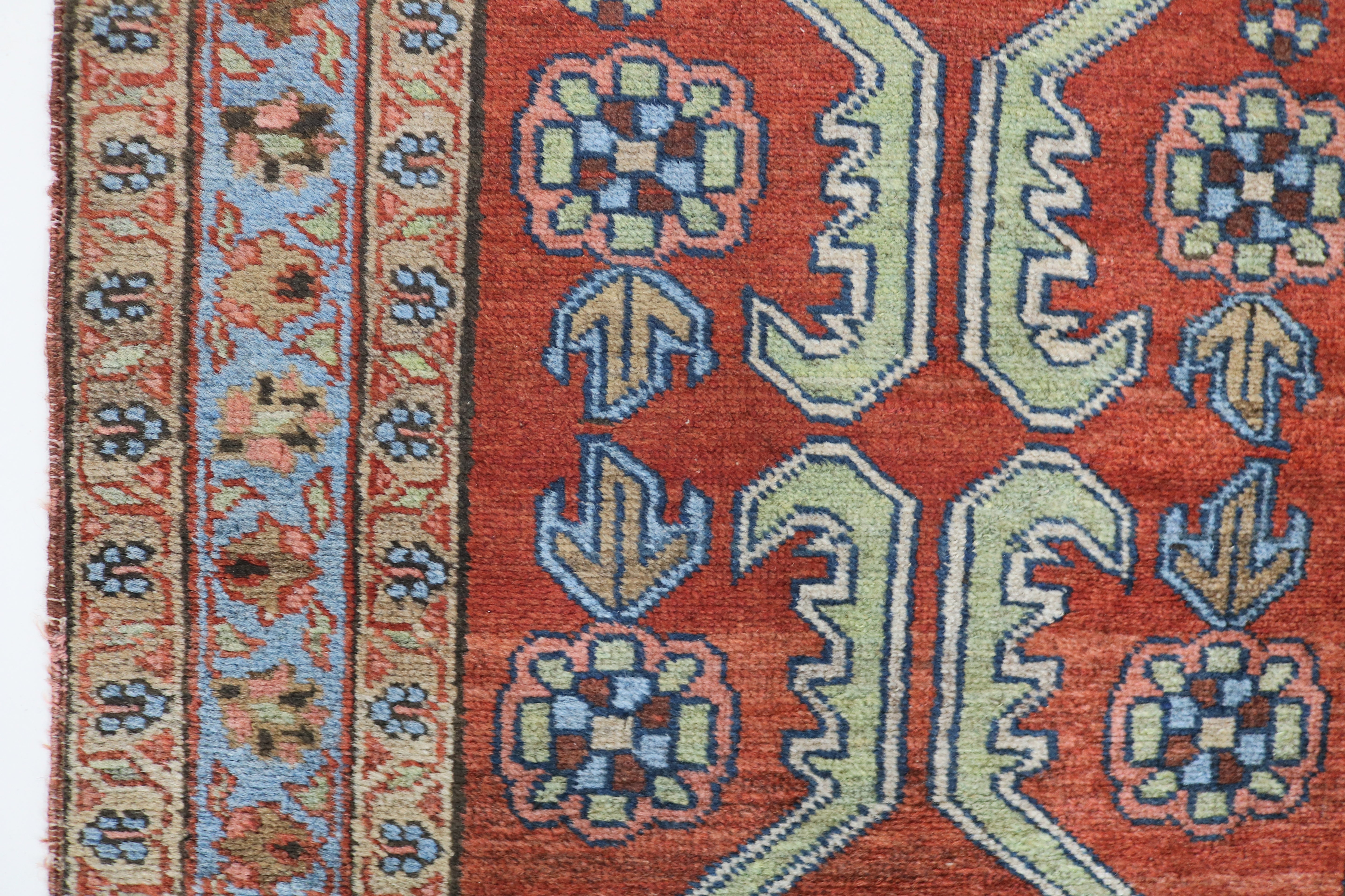 Close-up of hand-knotted wool texture on antique Persian Heriz rug
