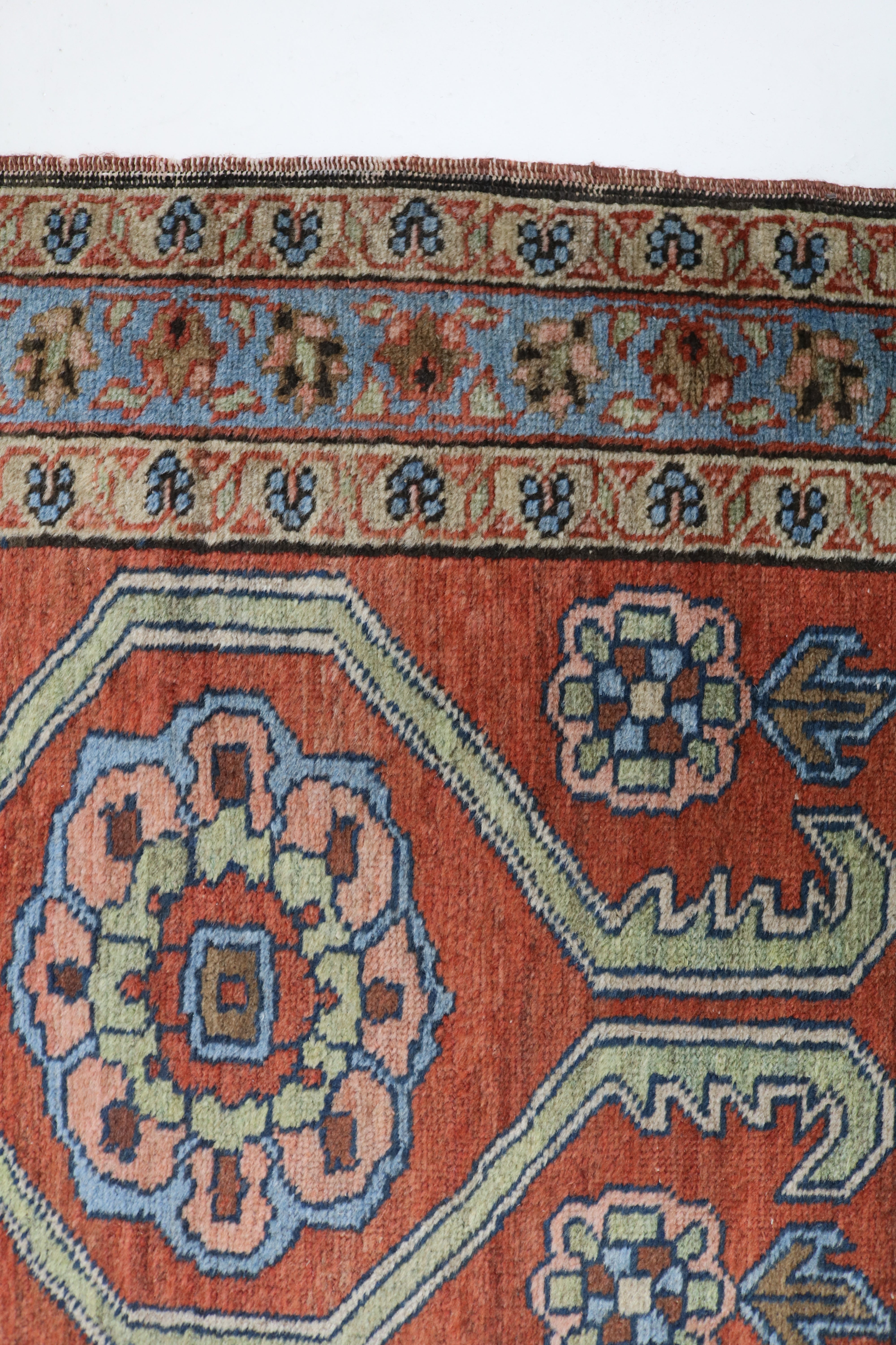 Close-up of hand-knotted wool texture on antique Persian Heriz rug