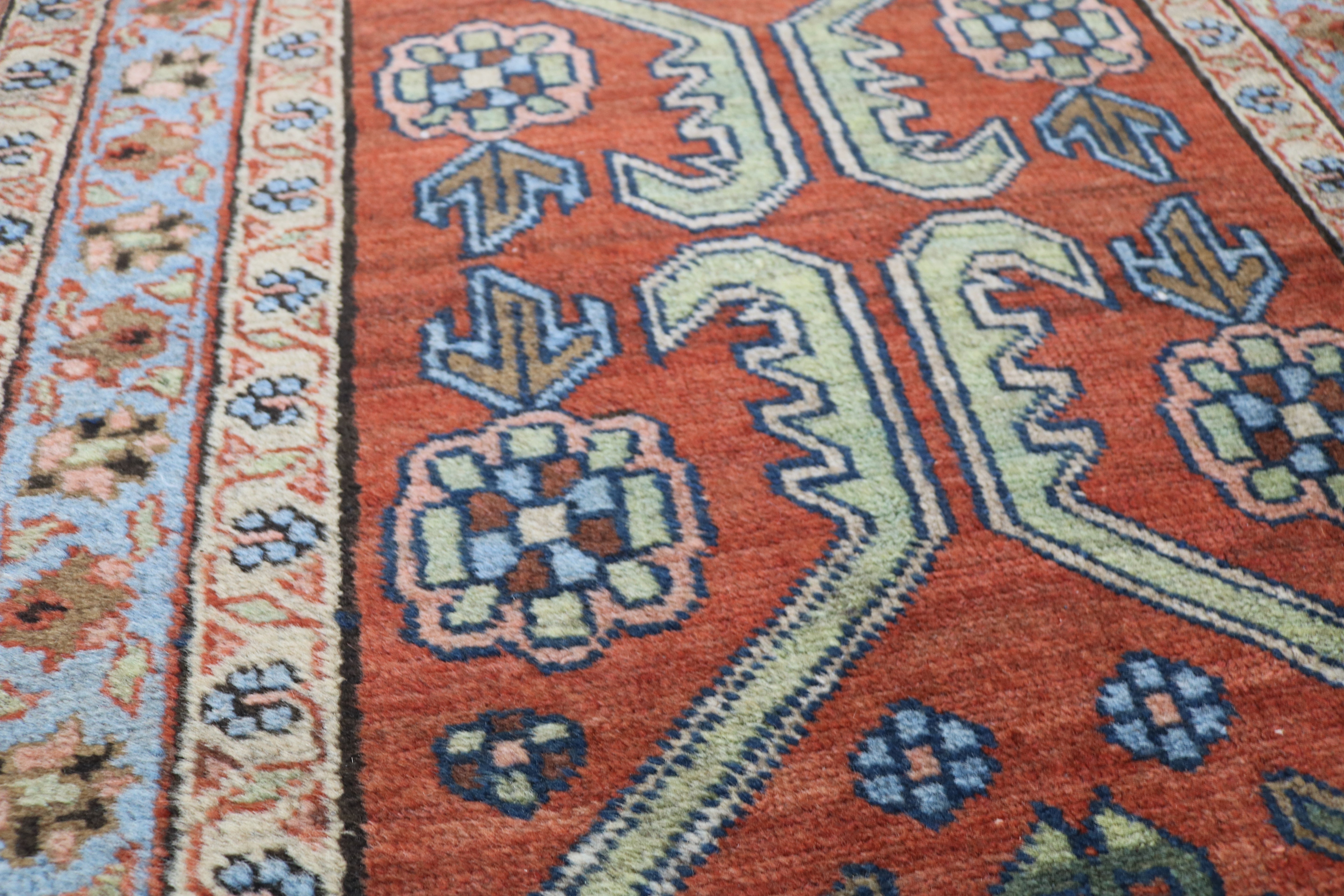 Close-up of hand-knotted wool texture on antique Persian Heriz rug