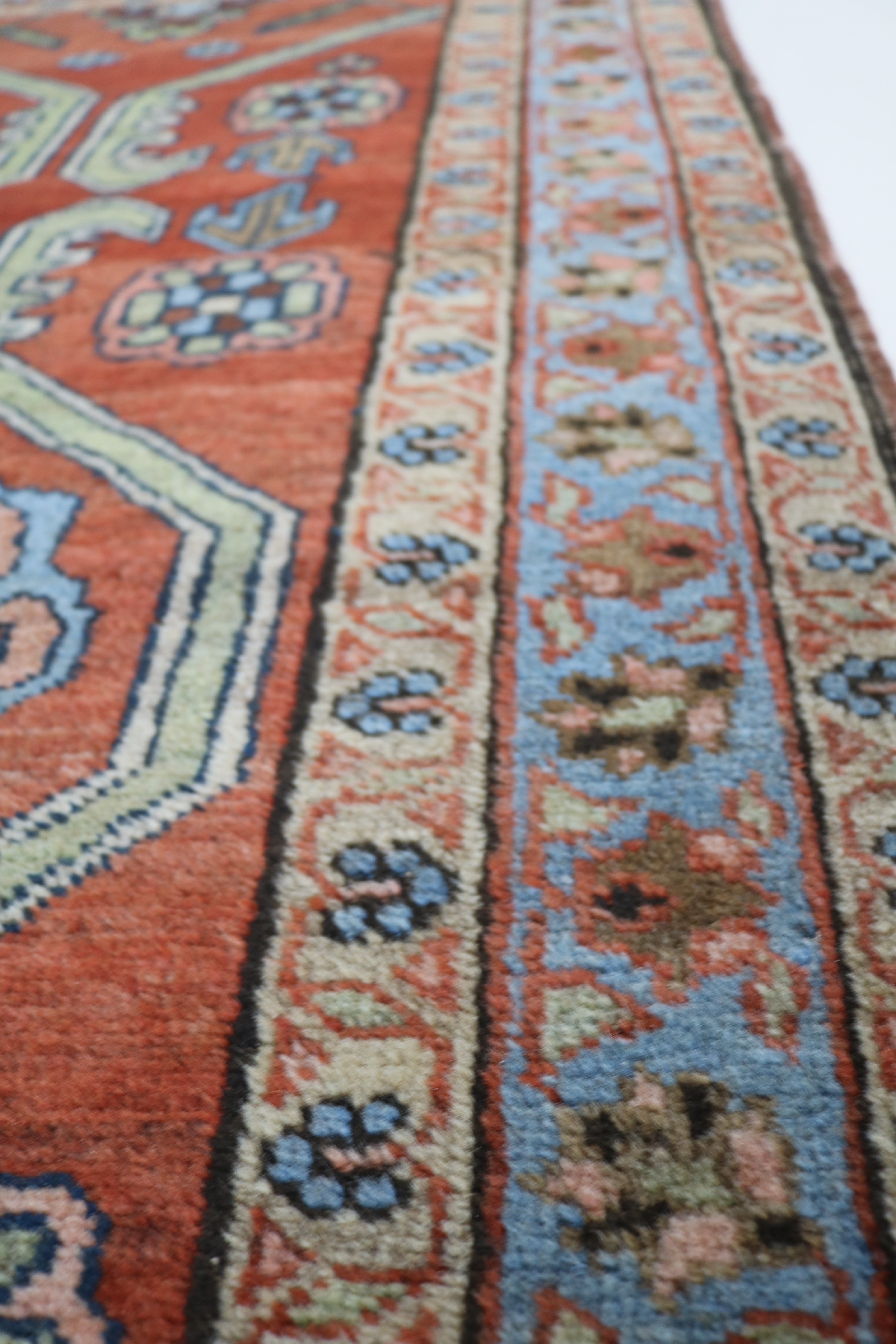 Close-up of hand-knotted wool texture on antique Persian Heriz rug