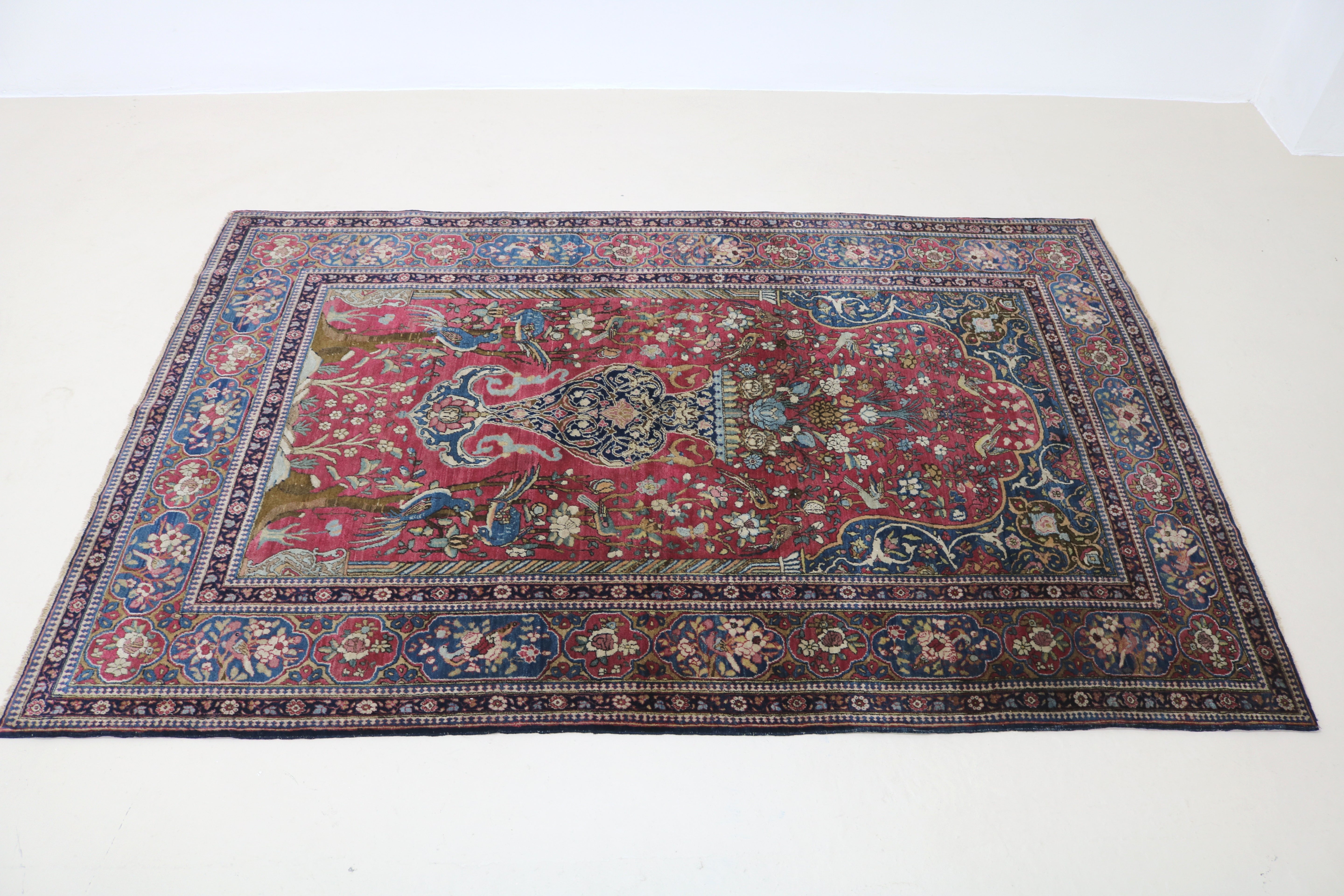 Perspective view of antique Isfahan rug laid on floor