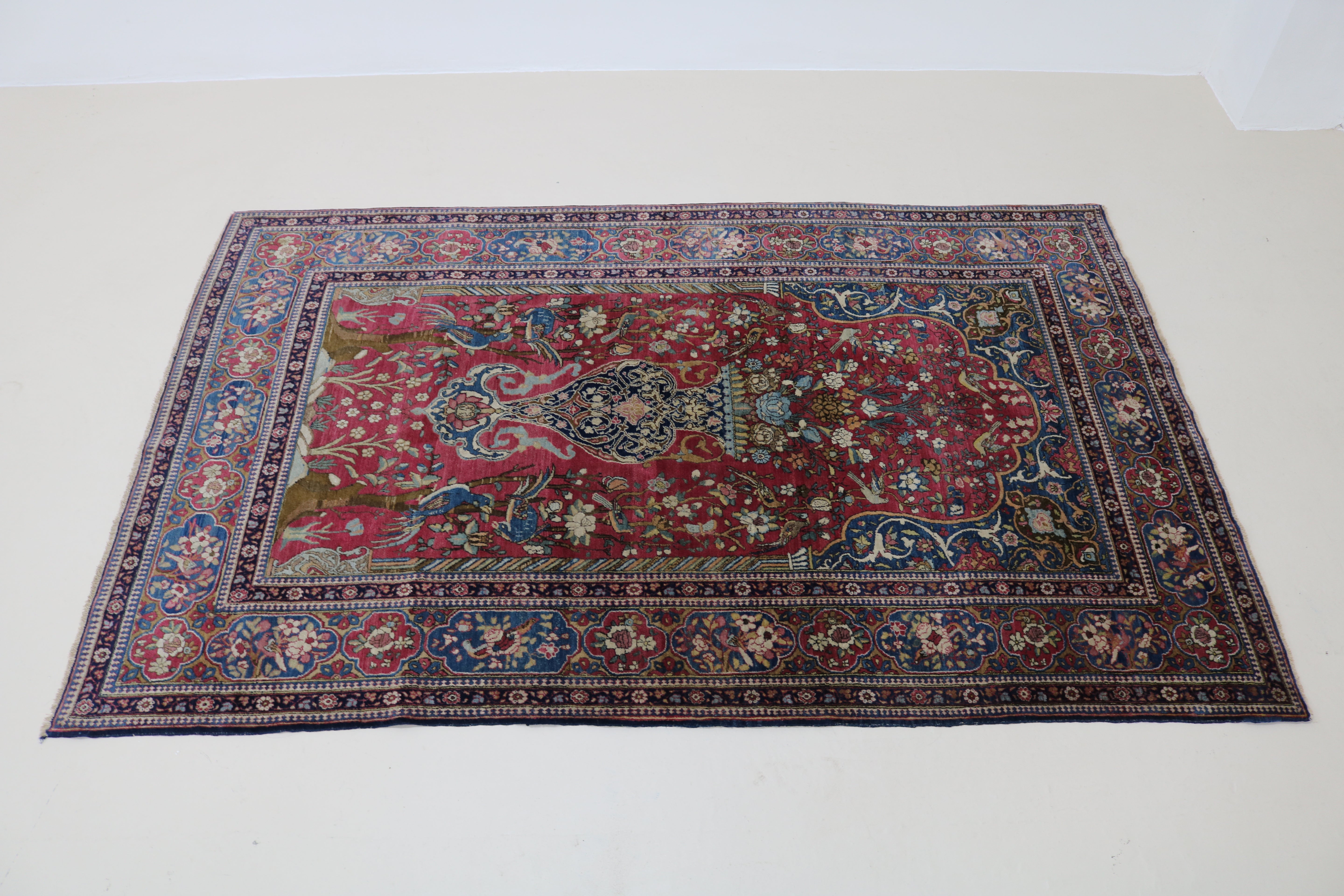 Perspective view of antique Isfahan rug laid on floor