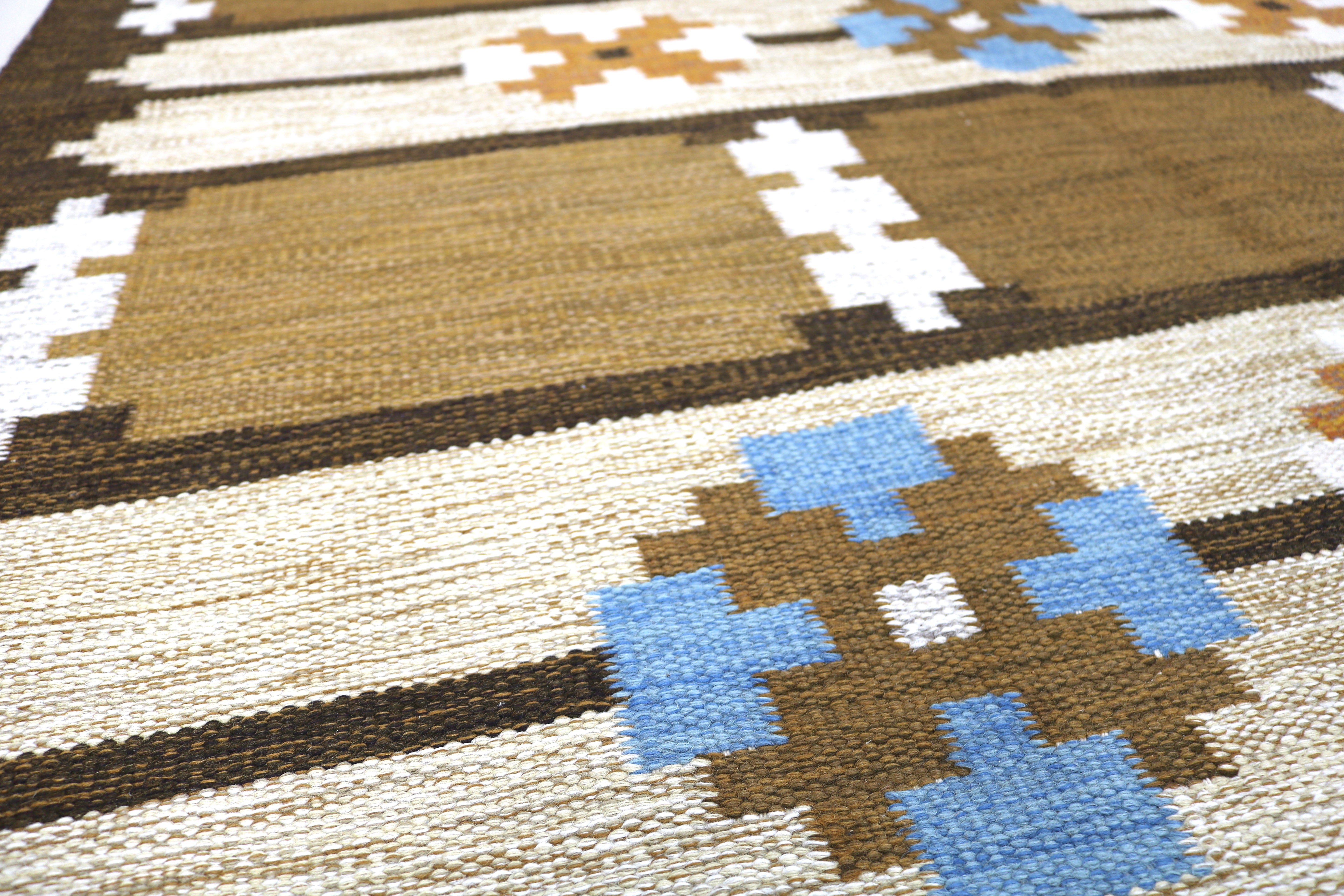 Detail of vintage Swedish flatweave rug showing ivory and brown striped design.