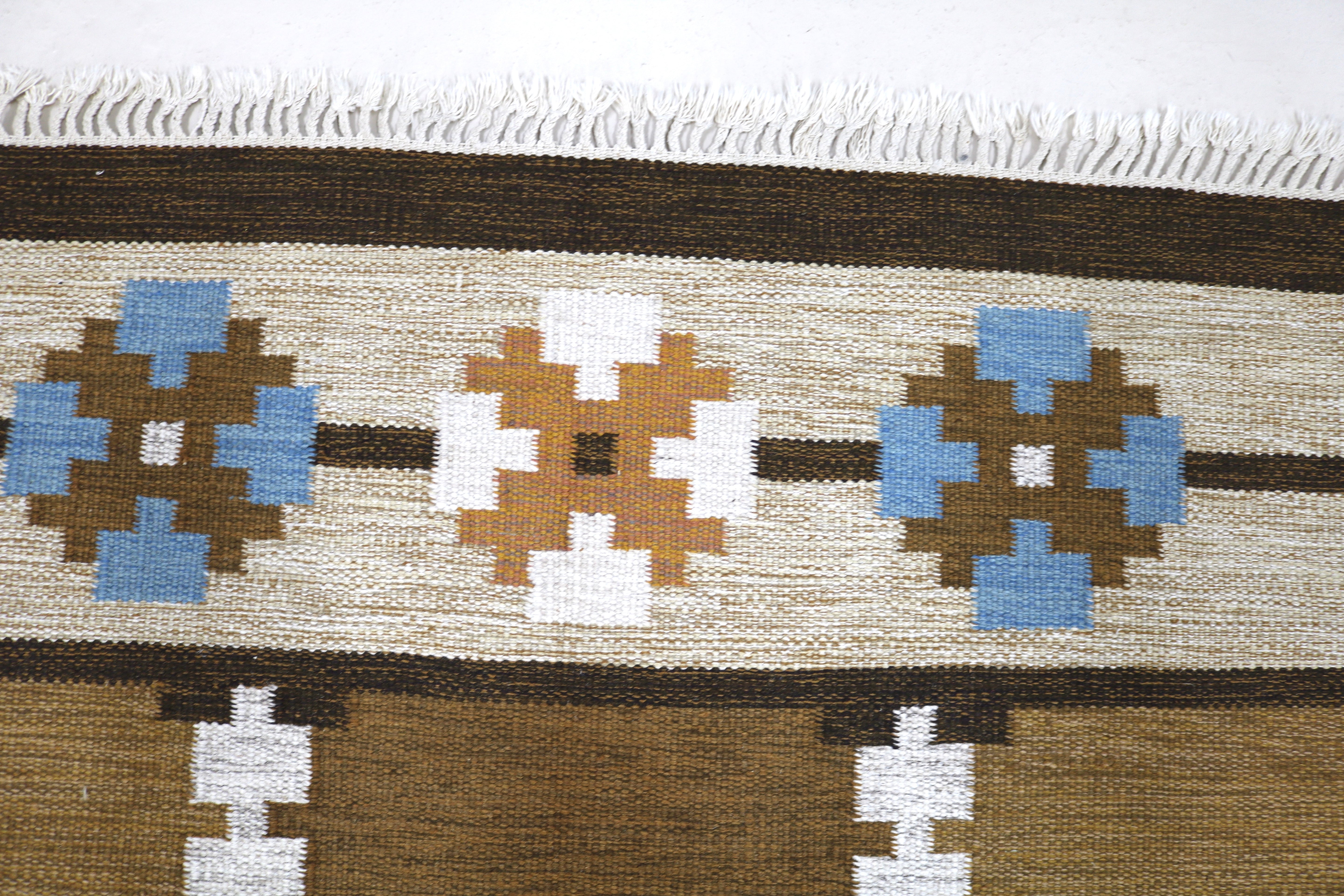 Close-up texture of authentic vintage Swedish wool flatweave rug.