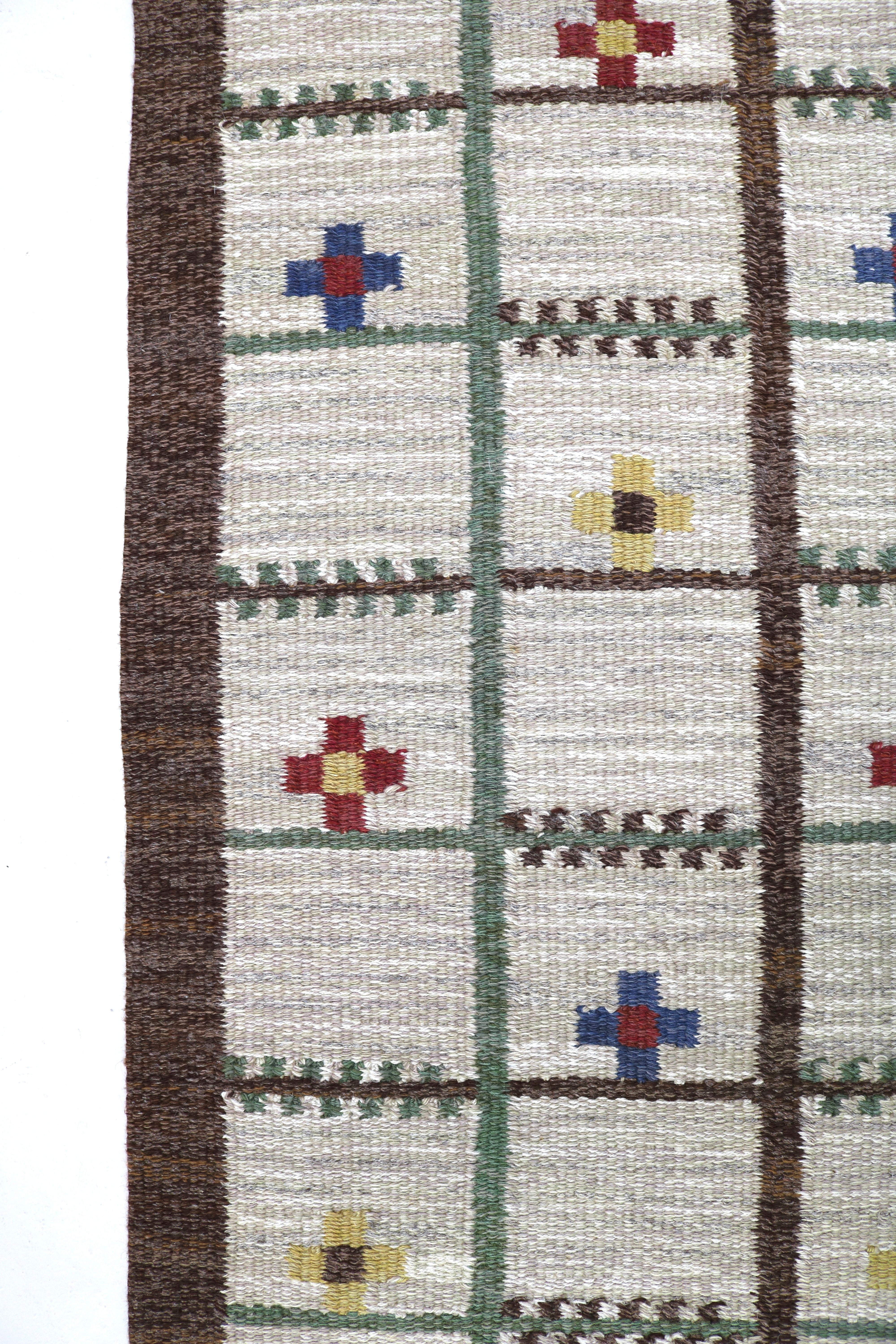 Detailed view of the colourful woven pattern on an authentic Scandinavian vintage rug.