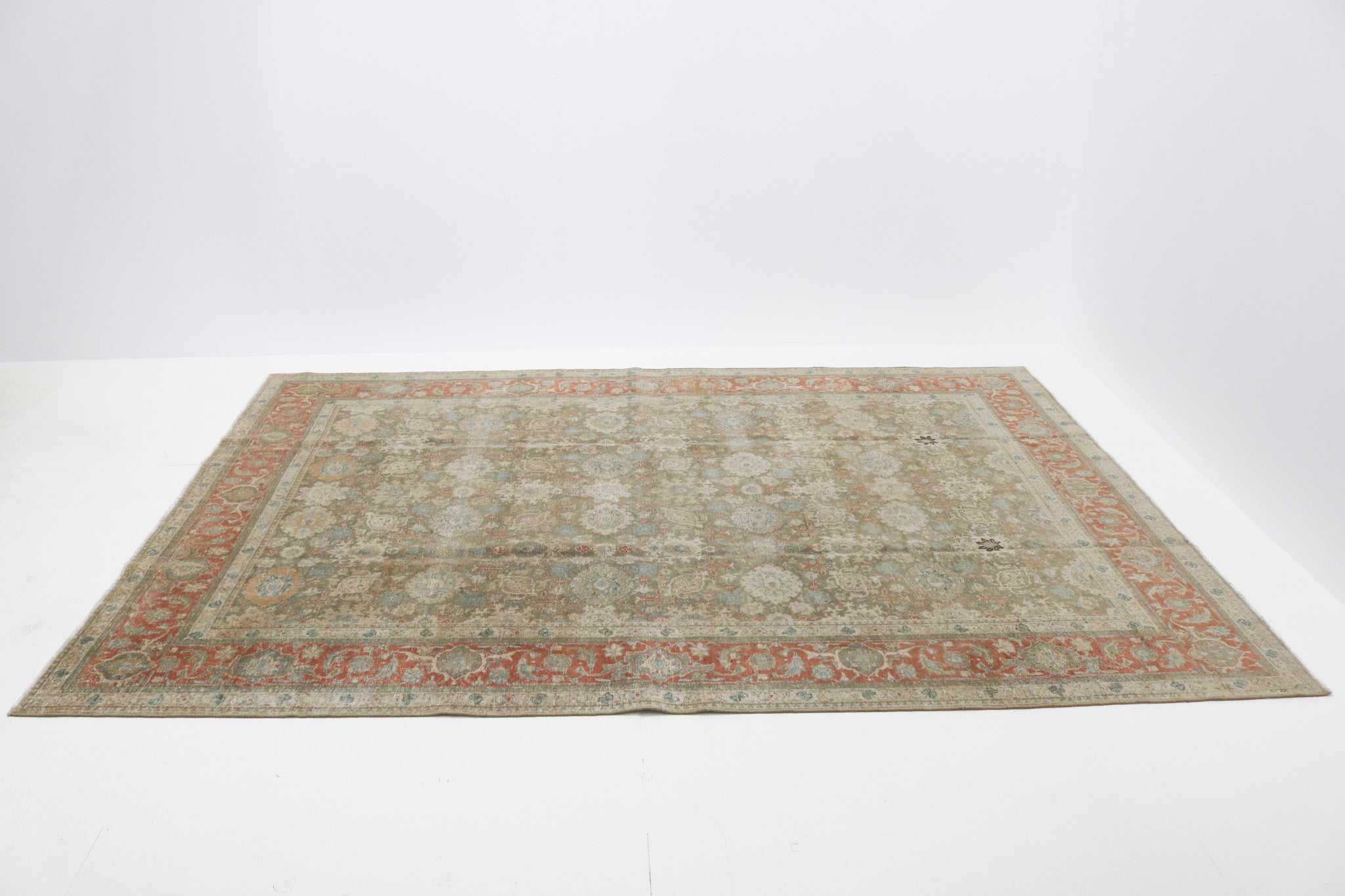Oversized antique Persian Heriz carpet circa 1920 displayed with traditional geometric medallion design