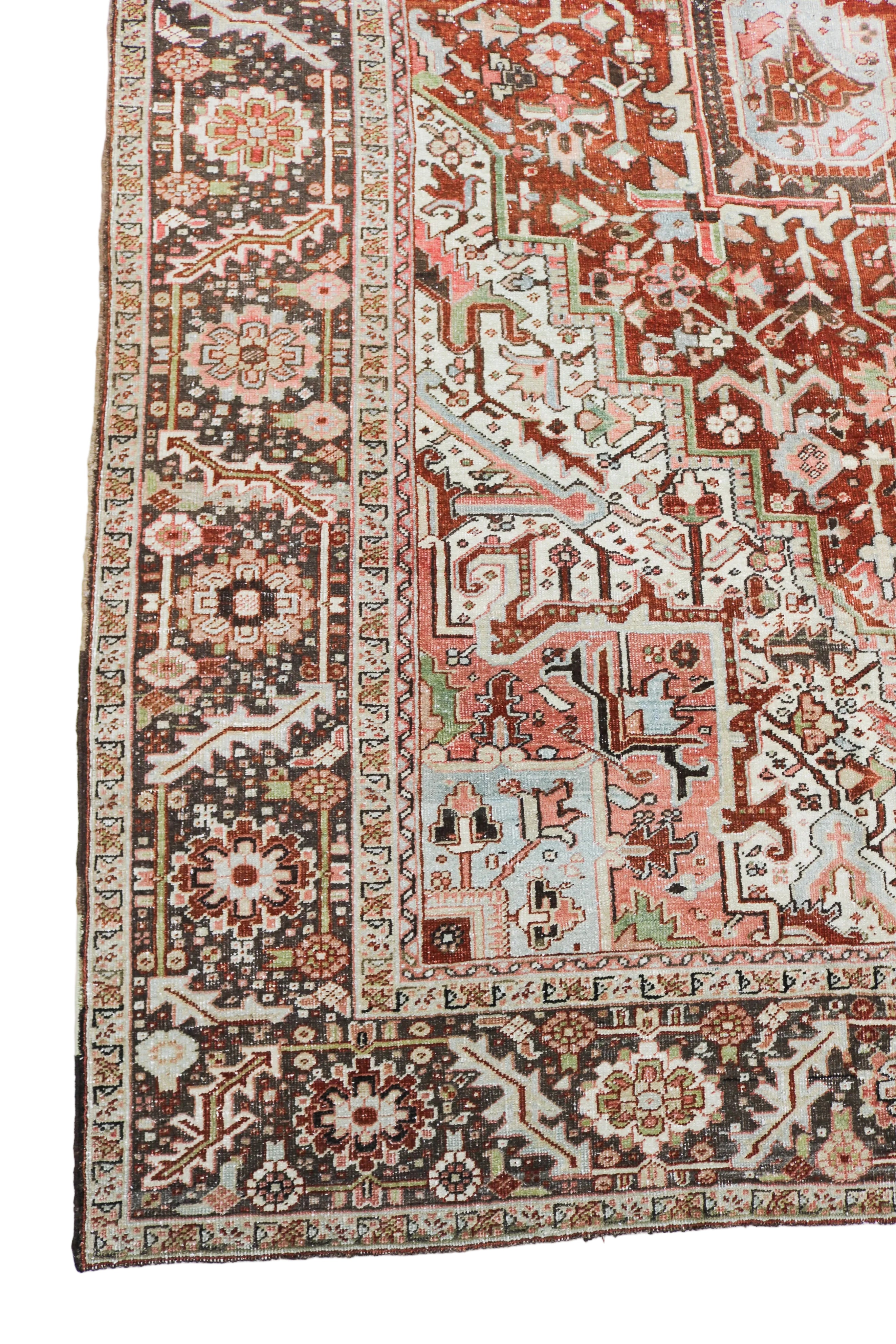 Antique Persian Heriz carpet corner detail with geometric border and terracotta medallion design circa 1920