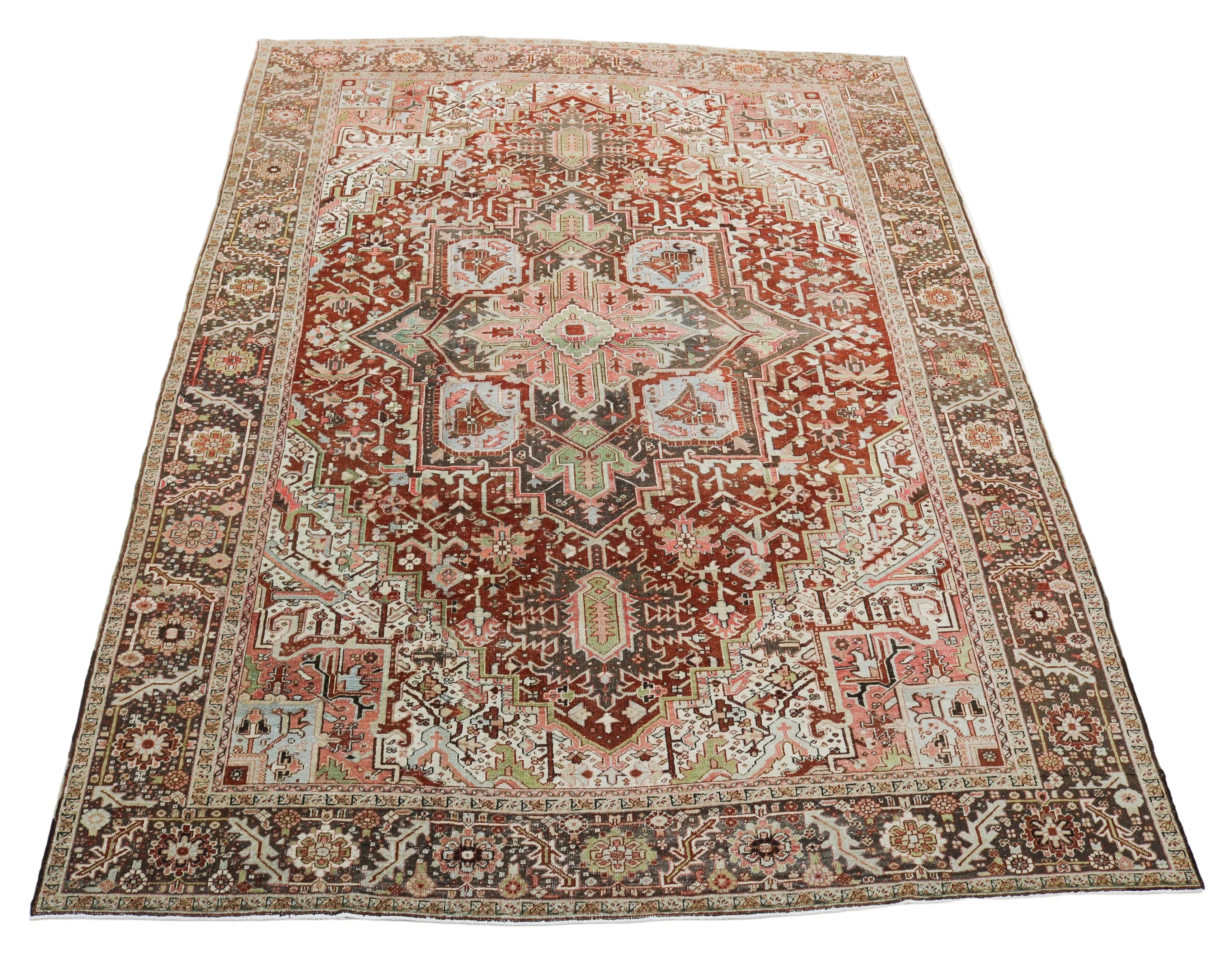 Large antique Persian Heriz carpet with central geometric medallion in terracotta and ivory tones