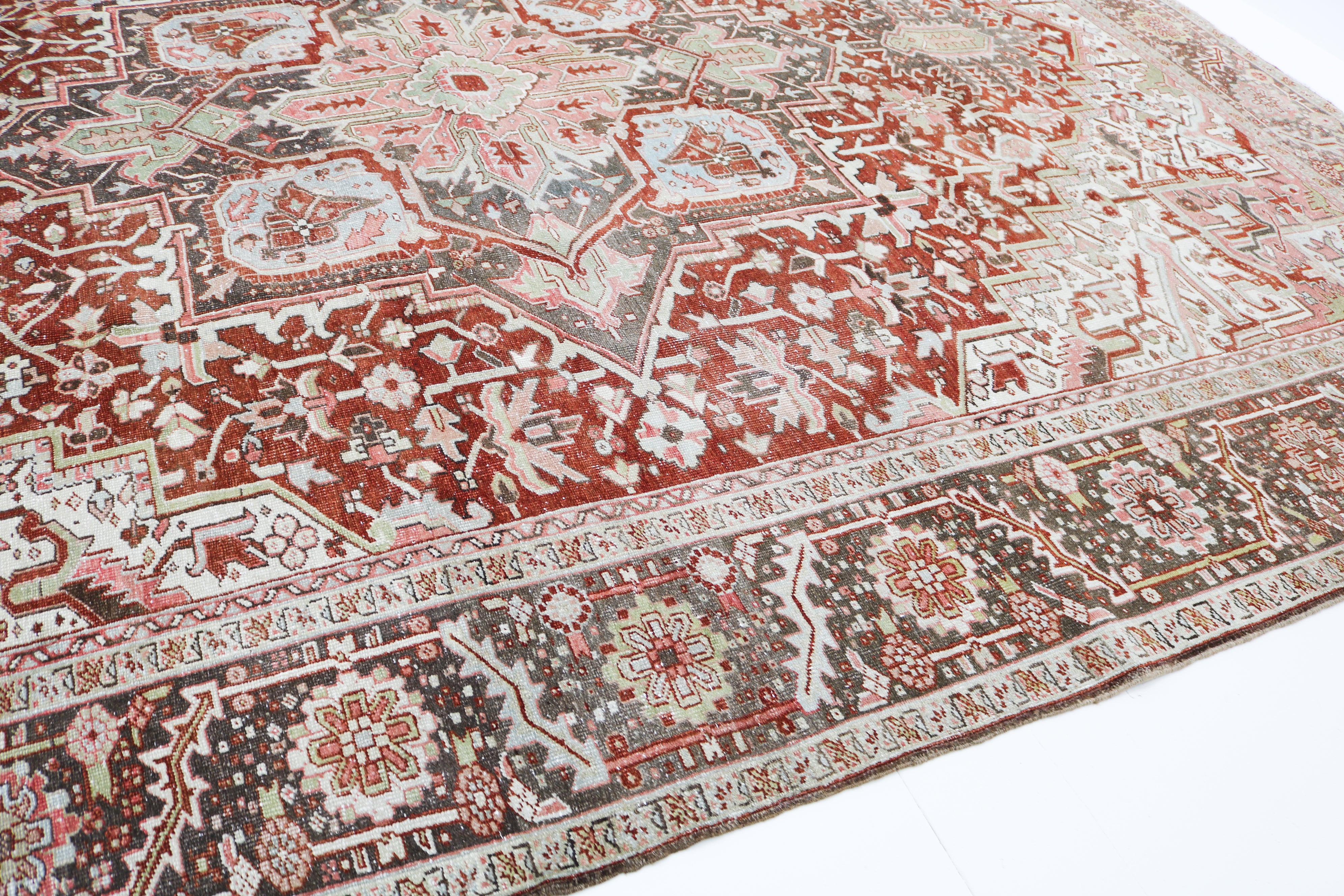 Close-up detail of antique Persian Heriz rug showing handwoven geometric motifs and natural wool colours