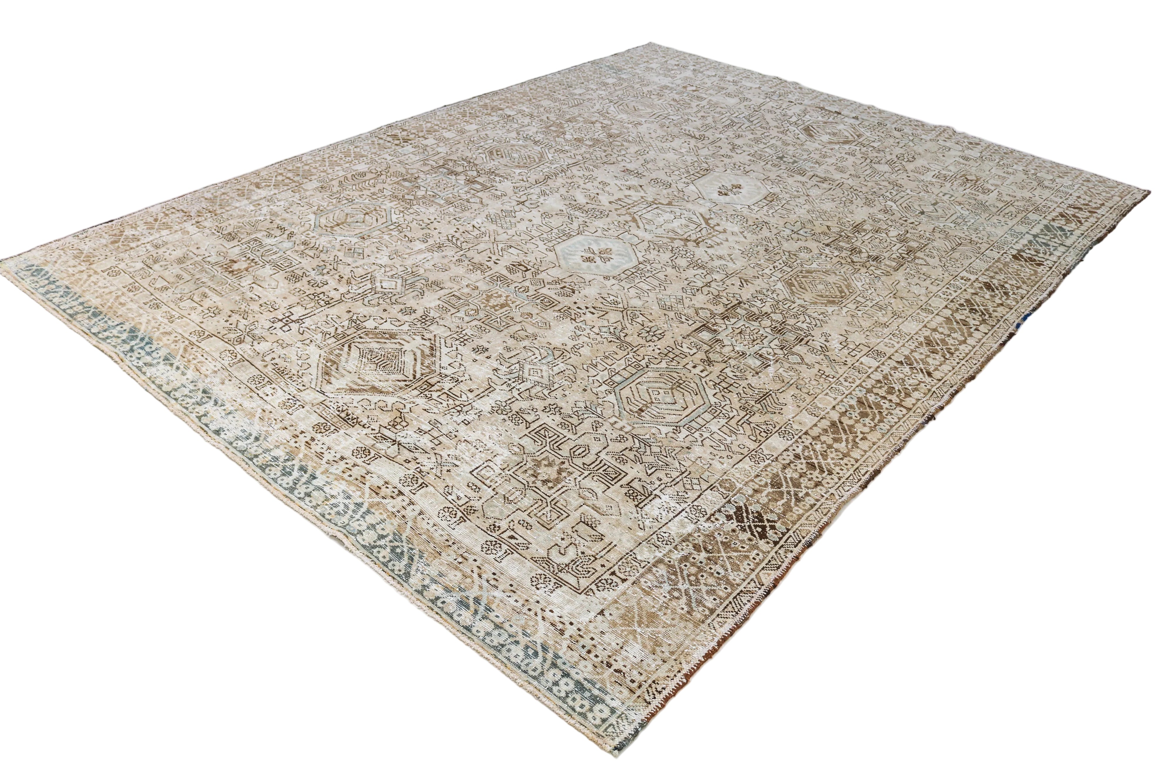 Hand-knotted antique Persian Heriz-Karaja rug with detailed tribal pattern and muted natural colours