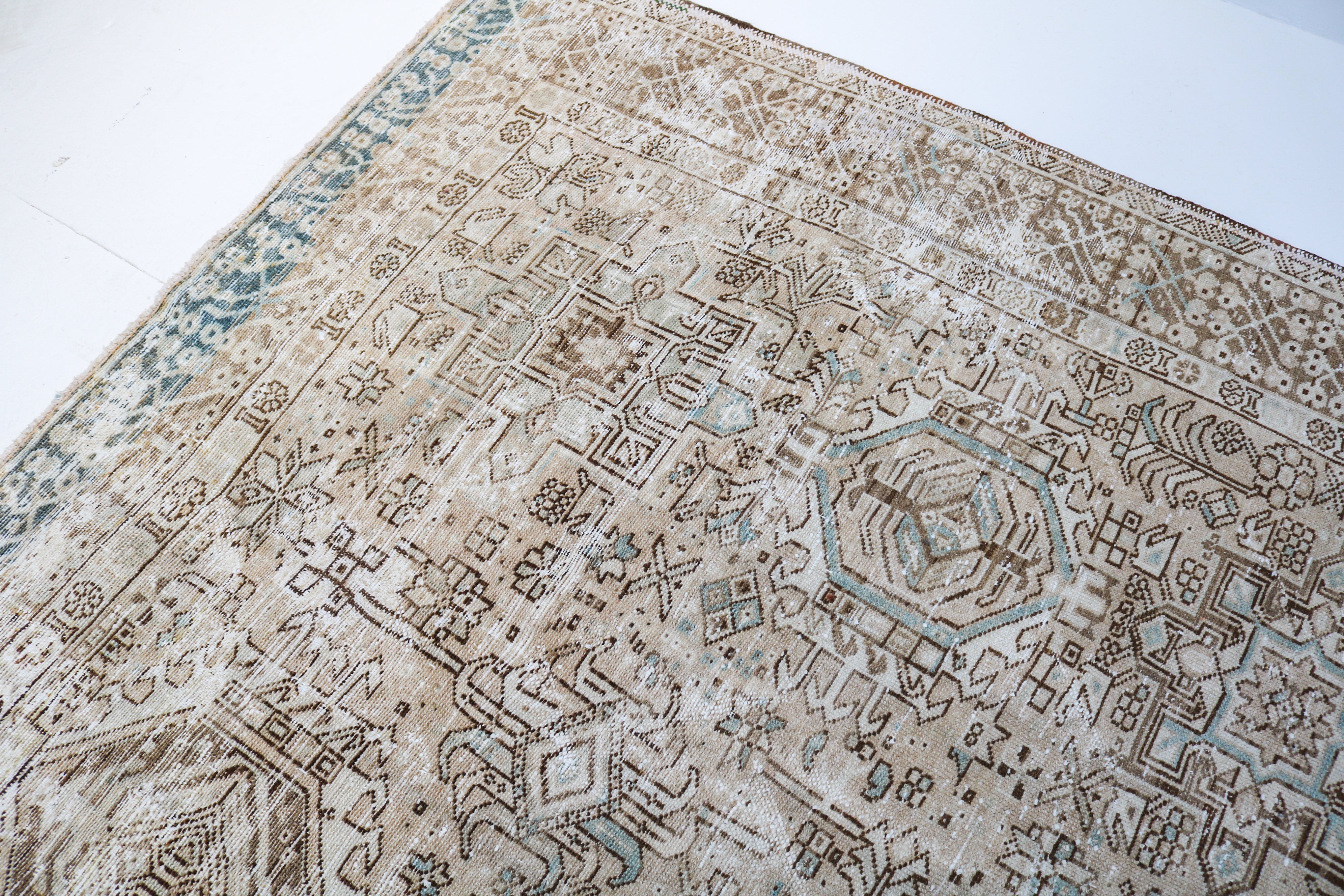 Antique Persian carpet close-up showing fine tribal weaving and subtle natural colour variation