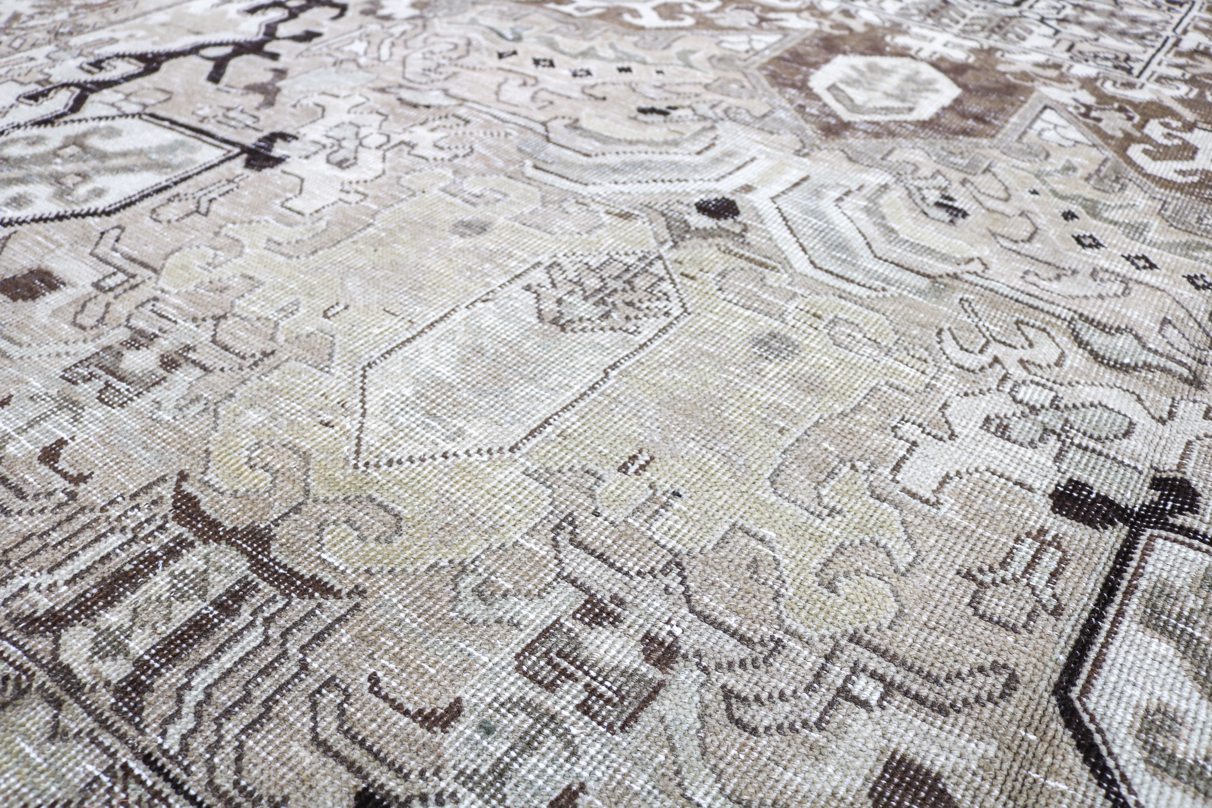 Handwoven Persian carpet detail with refined tribal drawing and authentic aged character