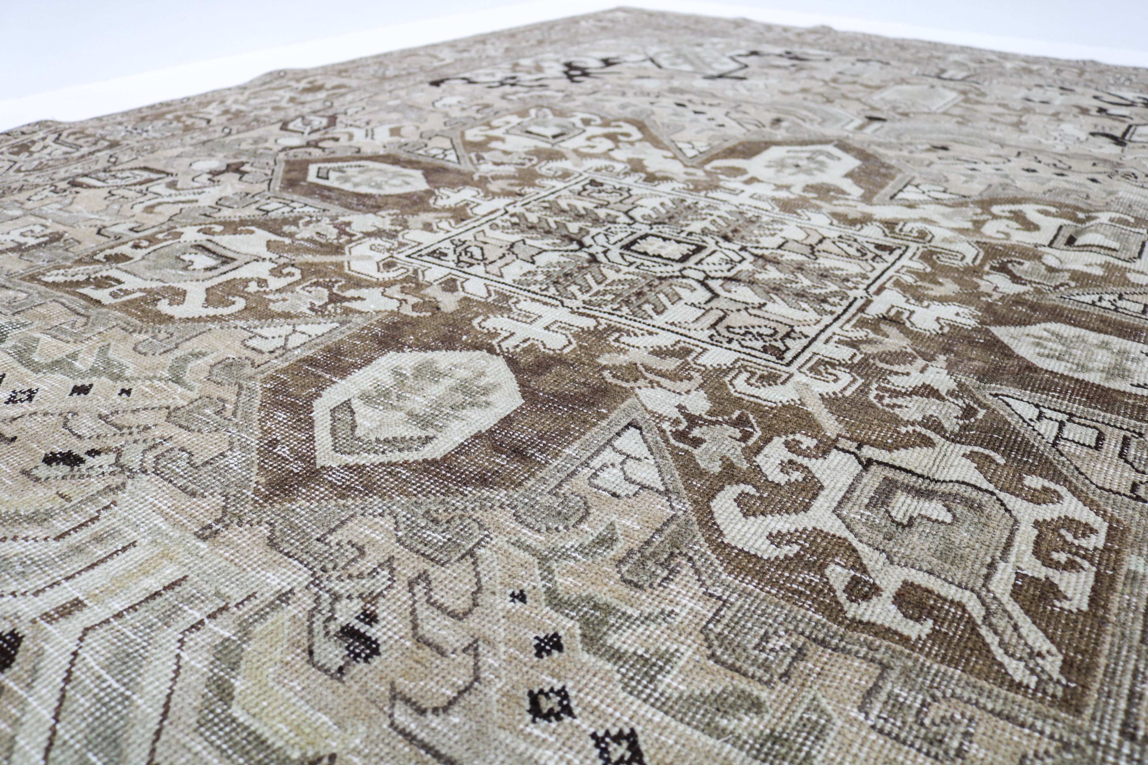 Vintage Persian rug close-up showing fine geometric weaving and subtle natural colour variation