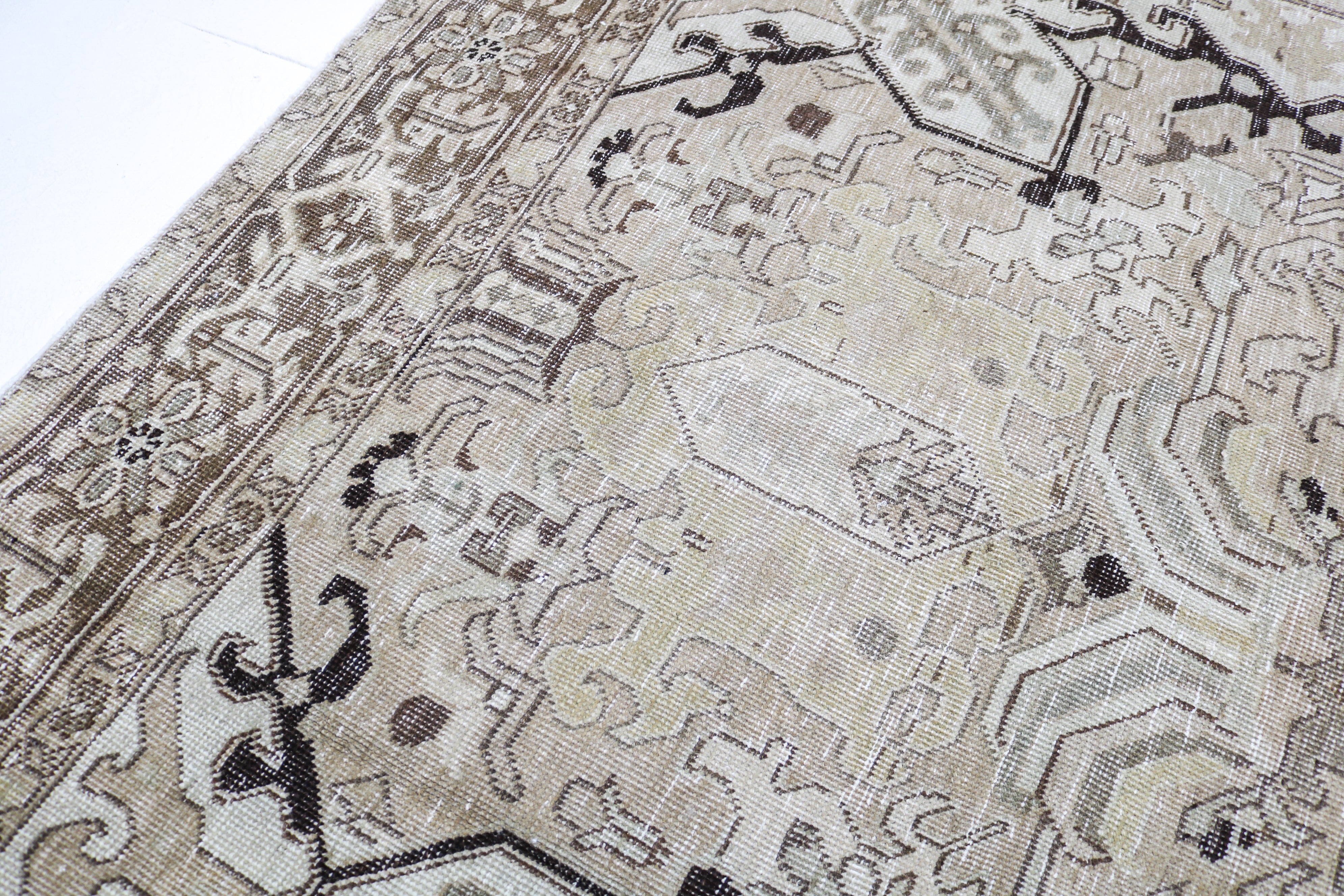 Vintage Persian rug close-up showing fine geometric weaving and subtle natural colour variation