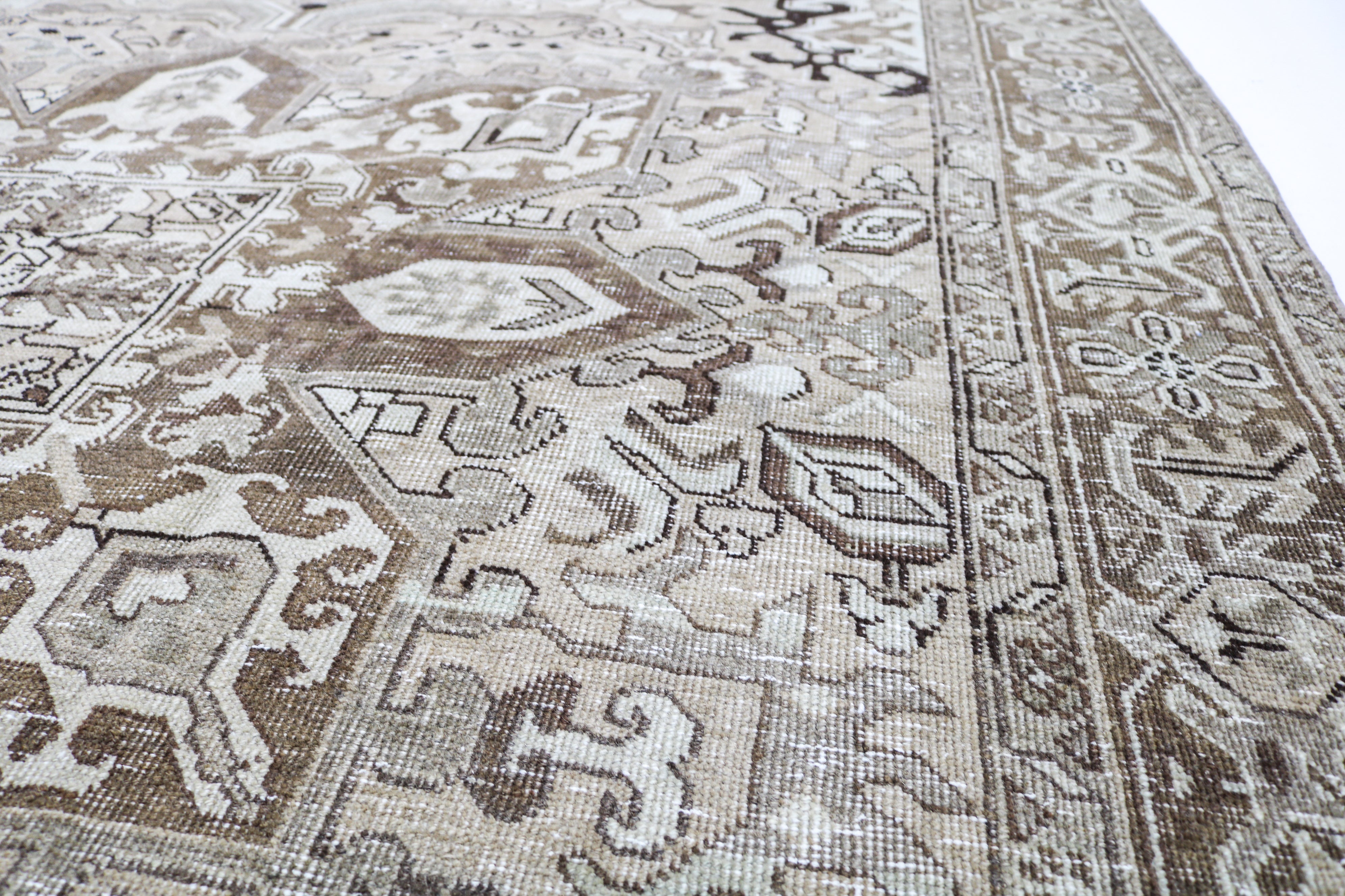 Vintage Persian rug close-up showing fine geometric weaving and subtle natural colour variation