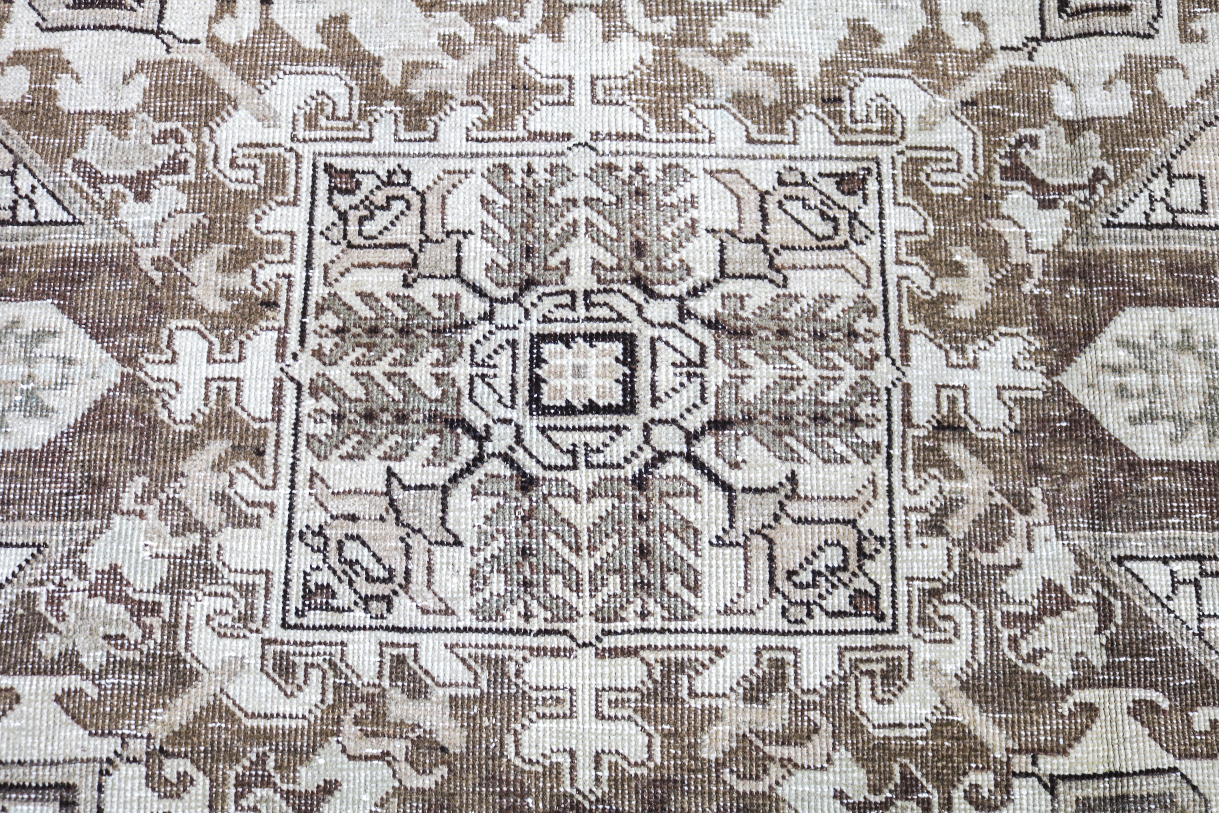 Vintage Persian rug close-up showing fine geometric weaving and subtle natural colour variation